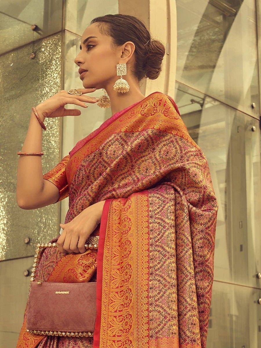 Woman in elegant red and gold designer saree with intricate paisley patterns, perfect for ethnic occasions