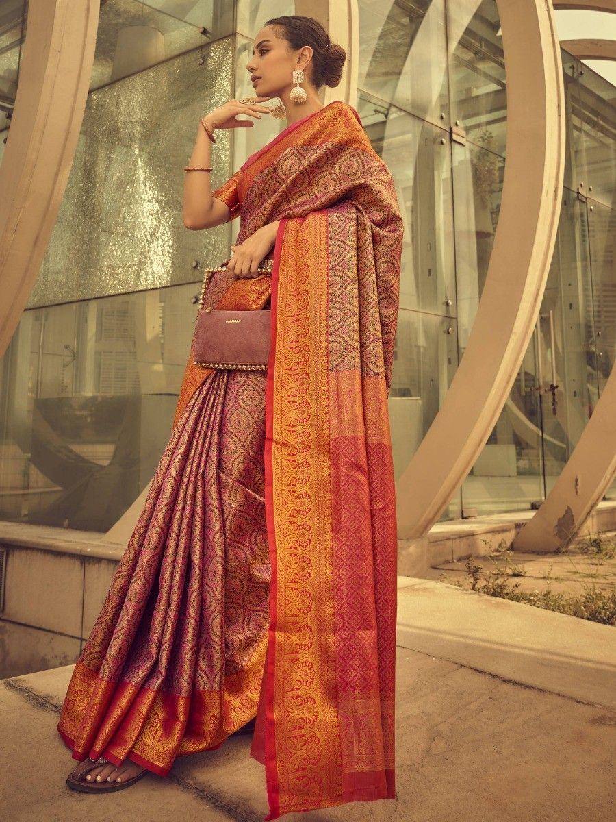 Woman in elegant red and gold designer saree with intricate patterns, perfect for Indian ethnic wear occasions.