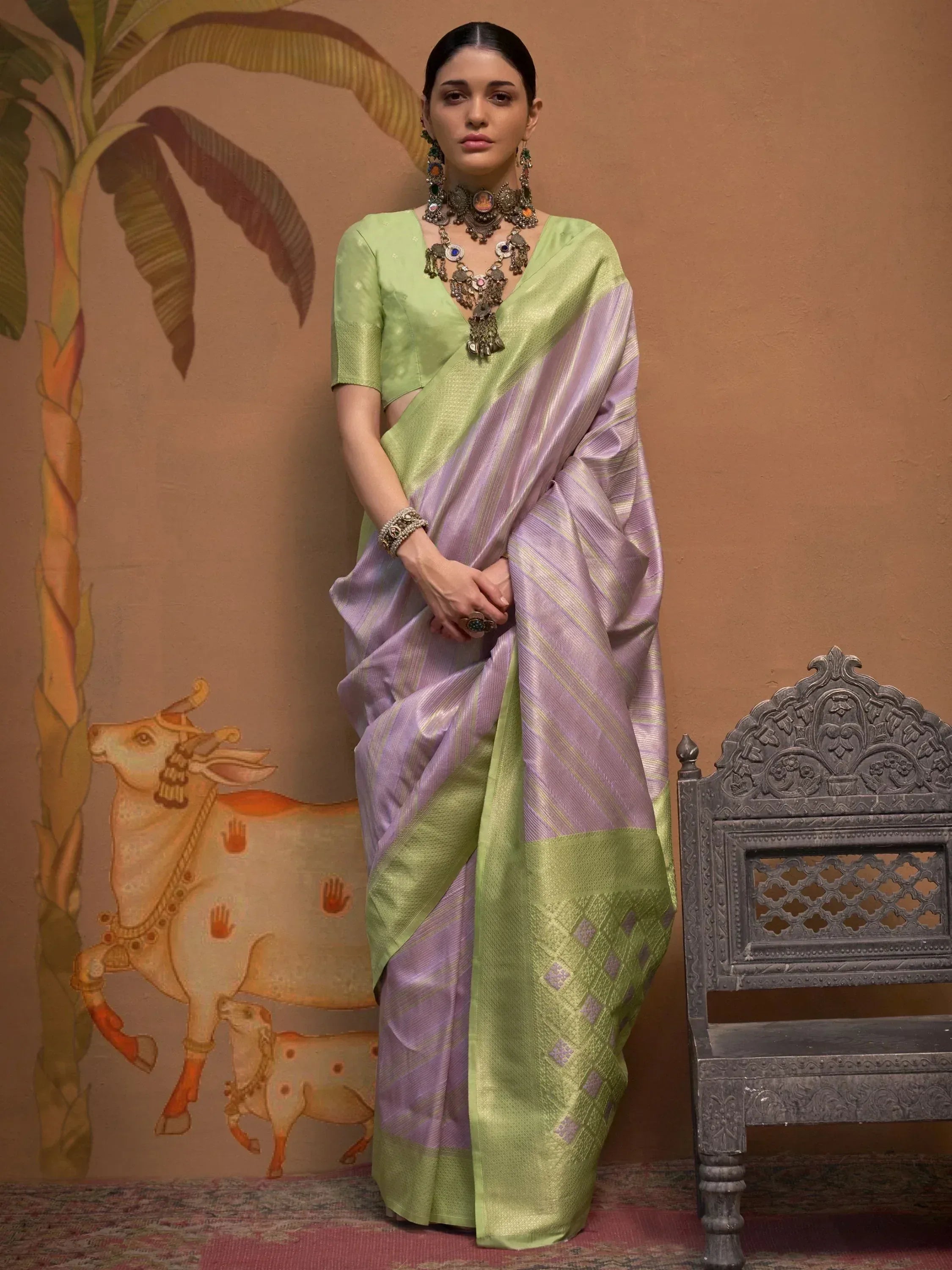 Woman in green and lavender silk saree with temple jewelry, Indian ethnic wear
