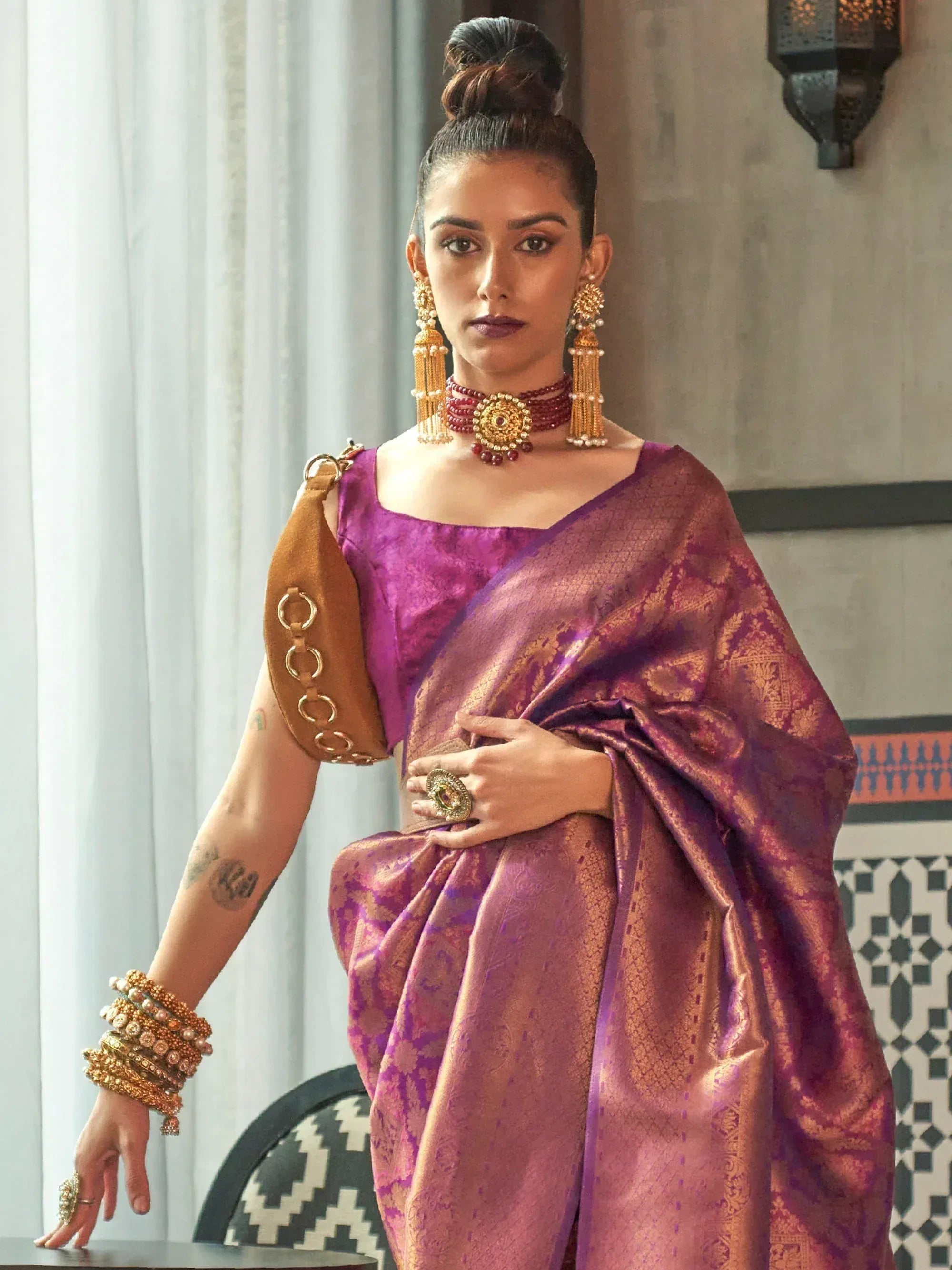 Purple and gold designer saree with statement jewelry, perfect for Indian ethnic wear occasions