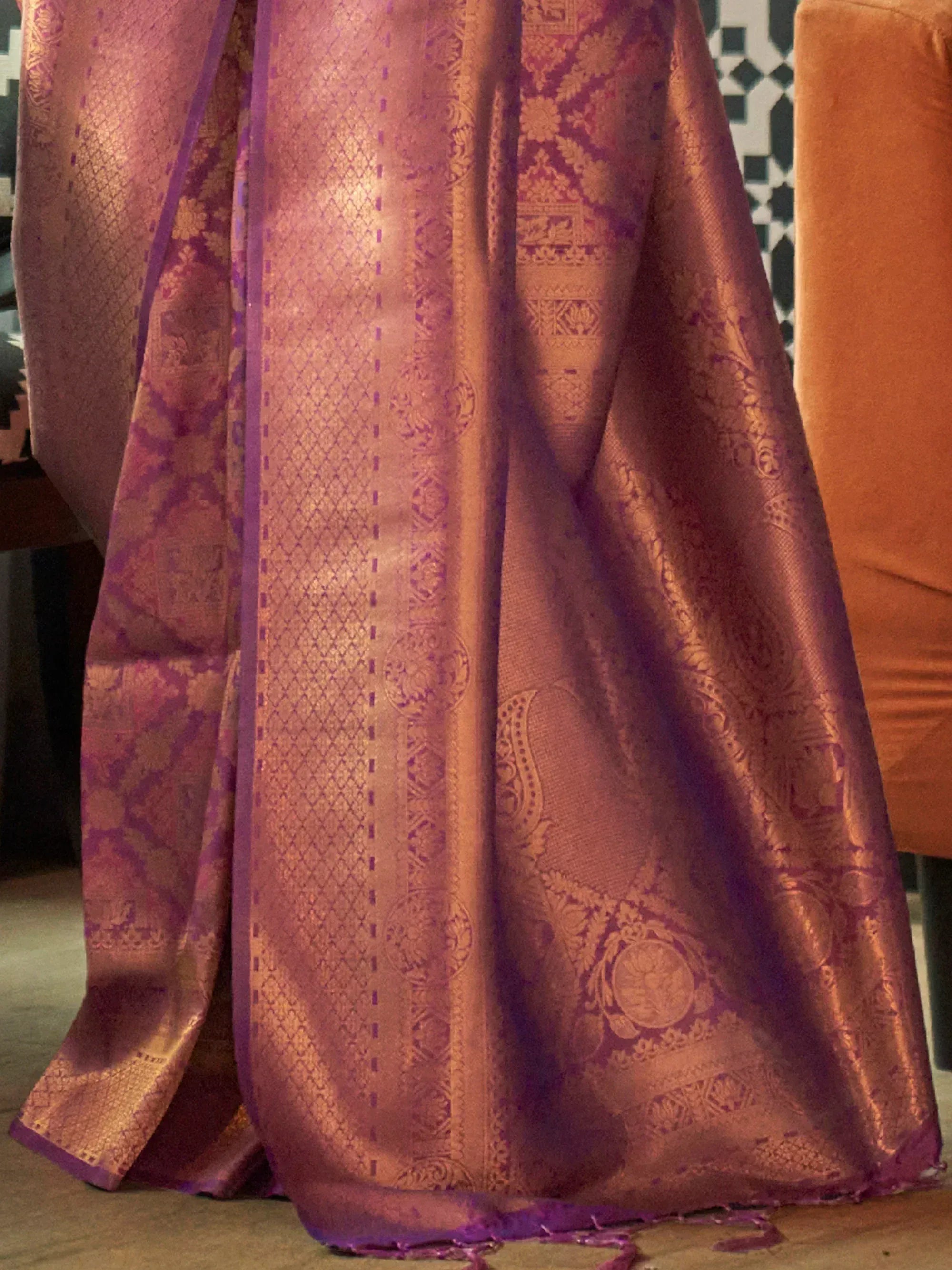 Luxurious purple and gold brocade saree with intricate floral and paisley patterns, perfect for ethnic occasions.