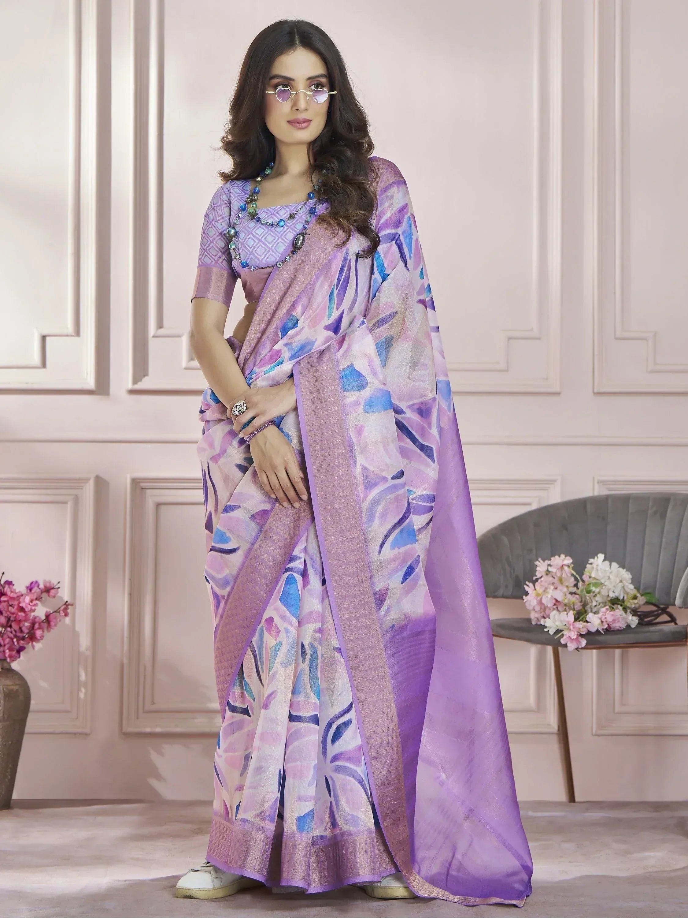 Purple and blue printed saree with matching blouse, styled with sunglasses and beads for ethnic wear