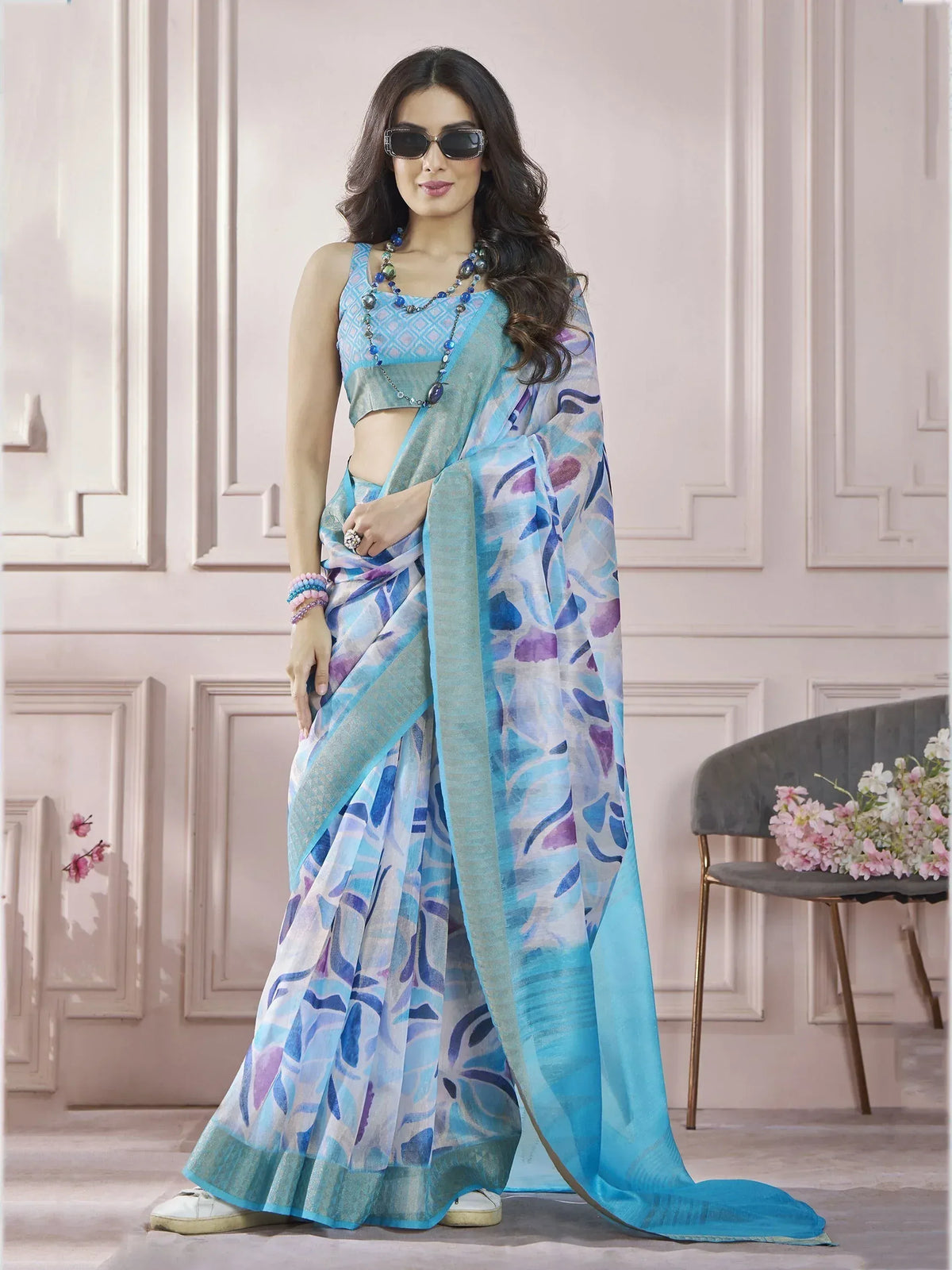 Blue and purple printed saree with matching blouse, styled with sunglasses and beads for ethnic wear