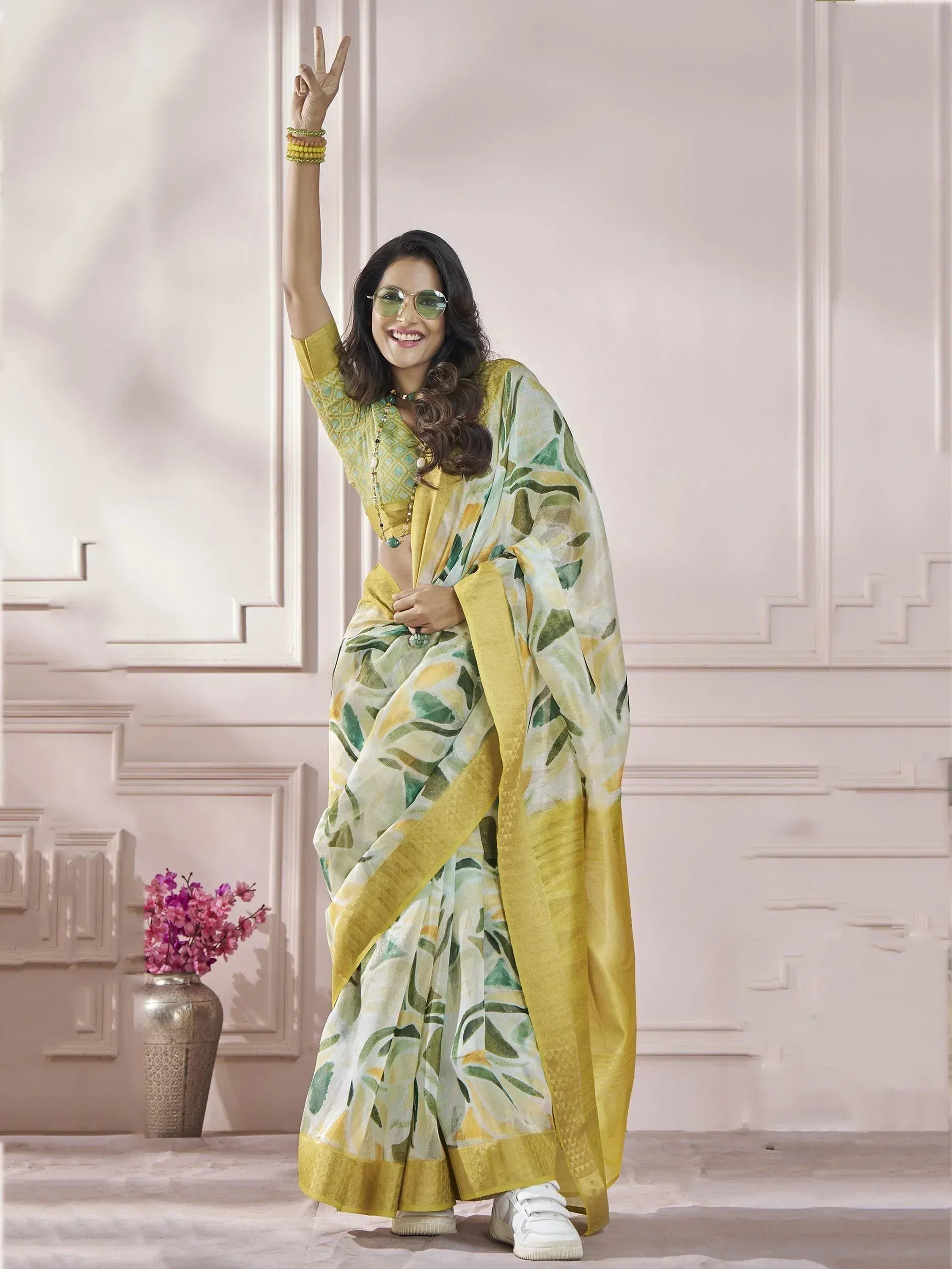 Woman in yellow green floral saree with gold border, stylish ethnic wear for festive occasions