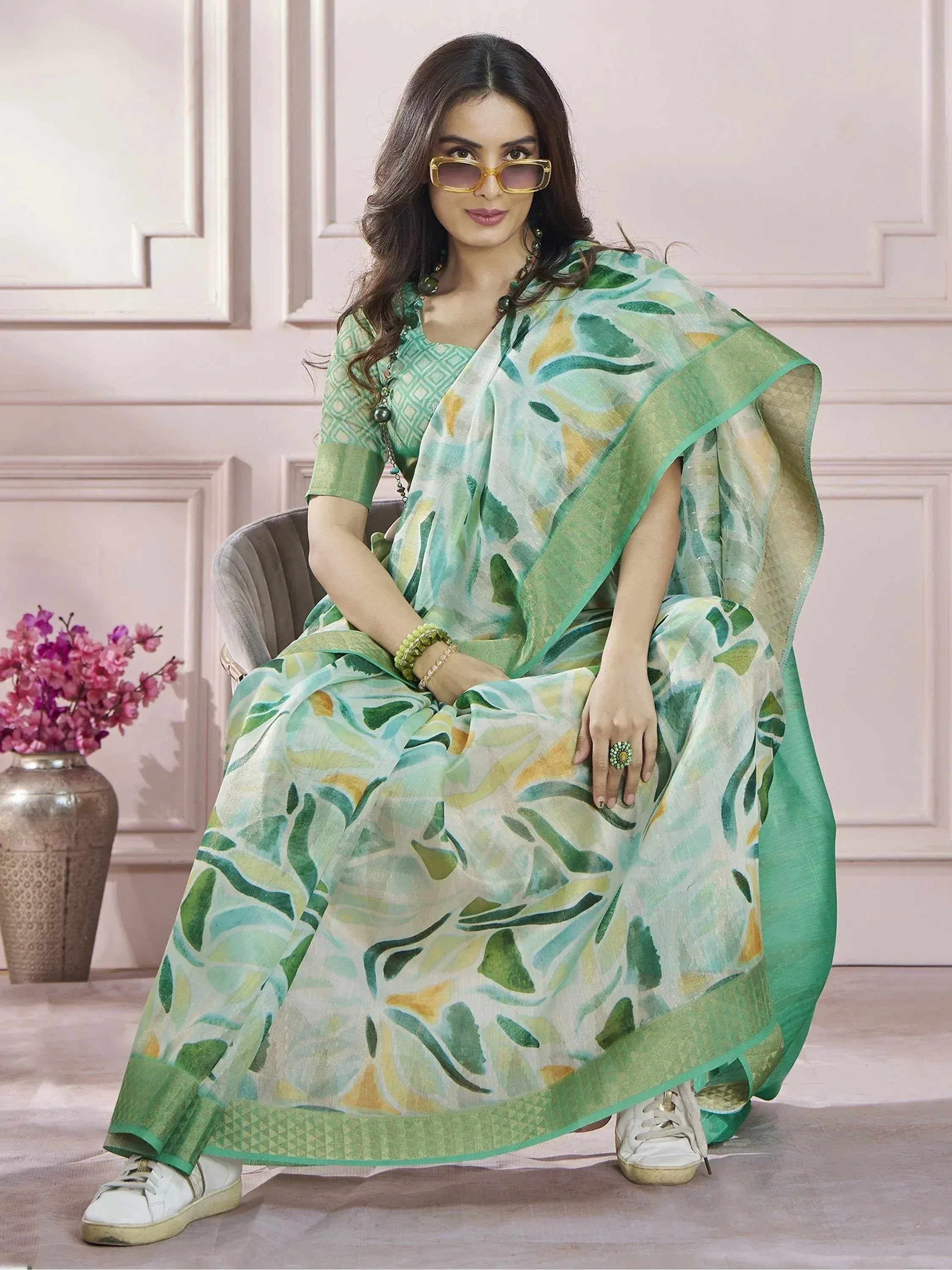 Green leaf print ethnic gown with matching dupatta, styled with white sneakers for a modern look.