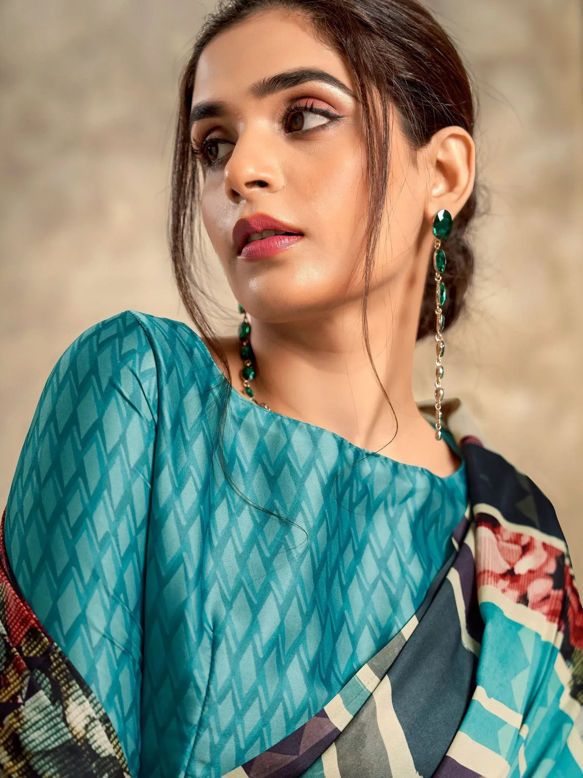 Woman in teal geometric print ethnic top with floral dupatta and green drop earrings