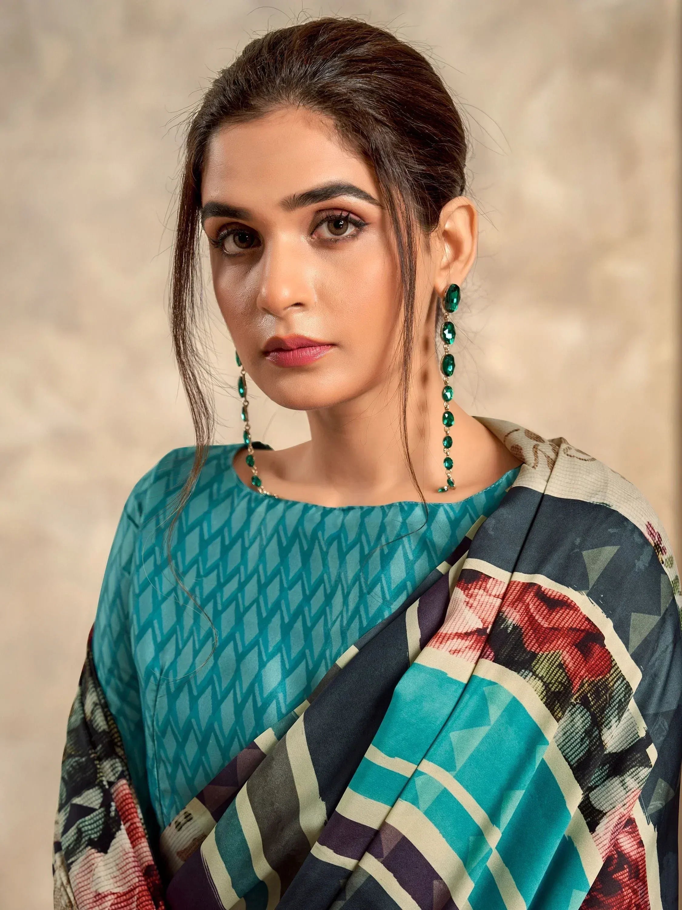 Woman in teal printed ethnic kurta with geometric dupatta and green drop earrings