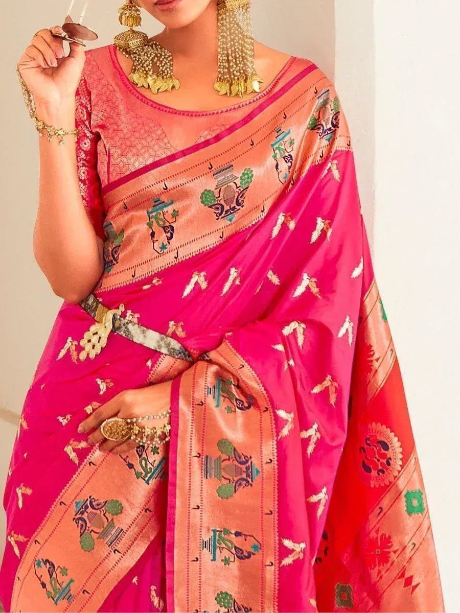 Pink and peach designer saree with temple motifs, paired with gold jewelry for ethnic wear