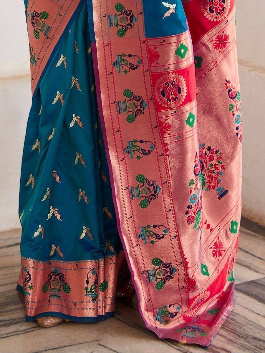Teal and pink ethnic saree with peacock and floral embroidery, perfect for Indian weddings and festivals