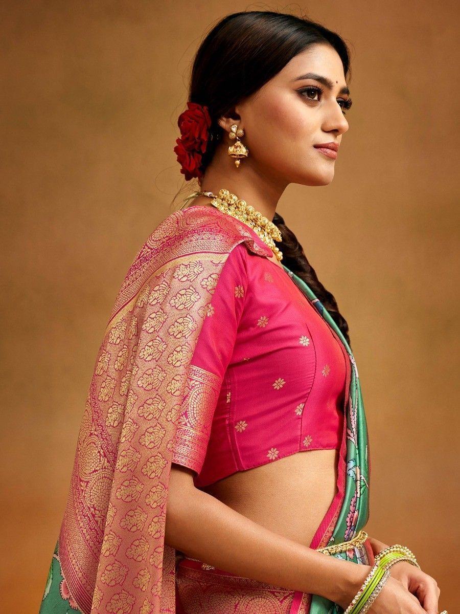 Woman in pink and green designer saree with gold embroidery, traditional Indian ethnic wear
