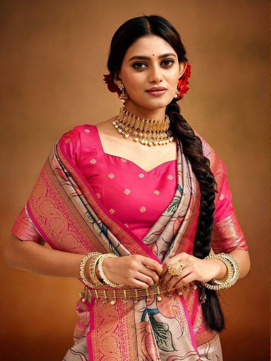Woman in pink floral saree with gold jewelry, traditional Indian ethnic wear
