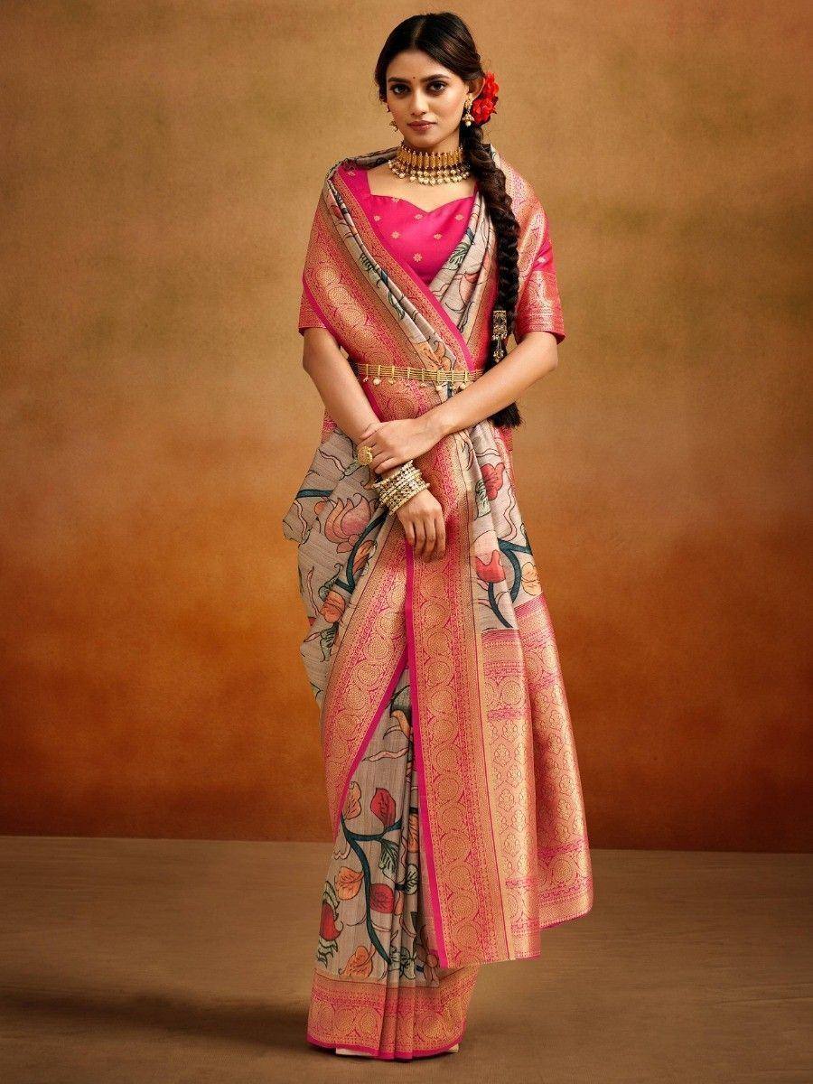 Woman in floral print saree with pink blouse, ethnic jewelry, and braided hair, showcasing traditional Indian wear.