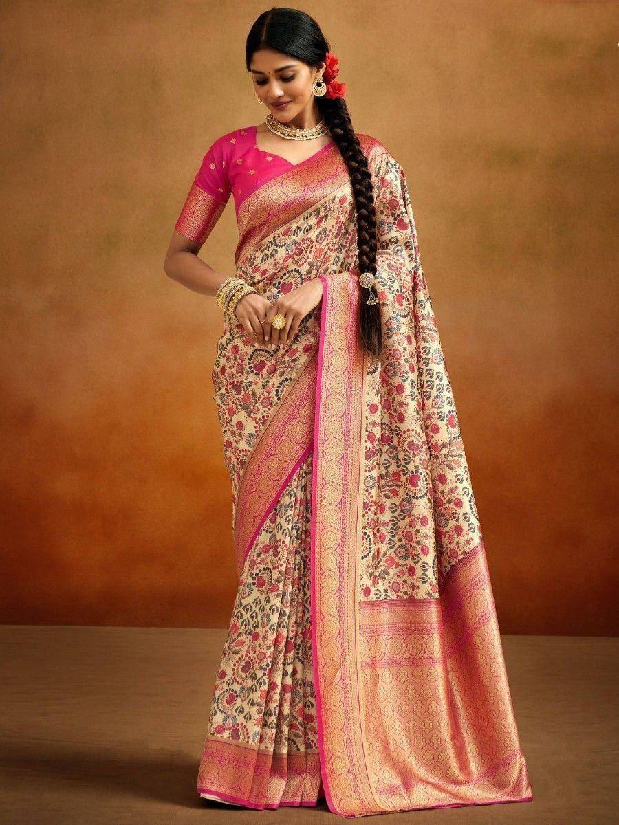Woman in floral print saree with pink border and blouse, traditional Indian ethnic wear