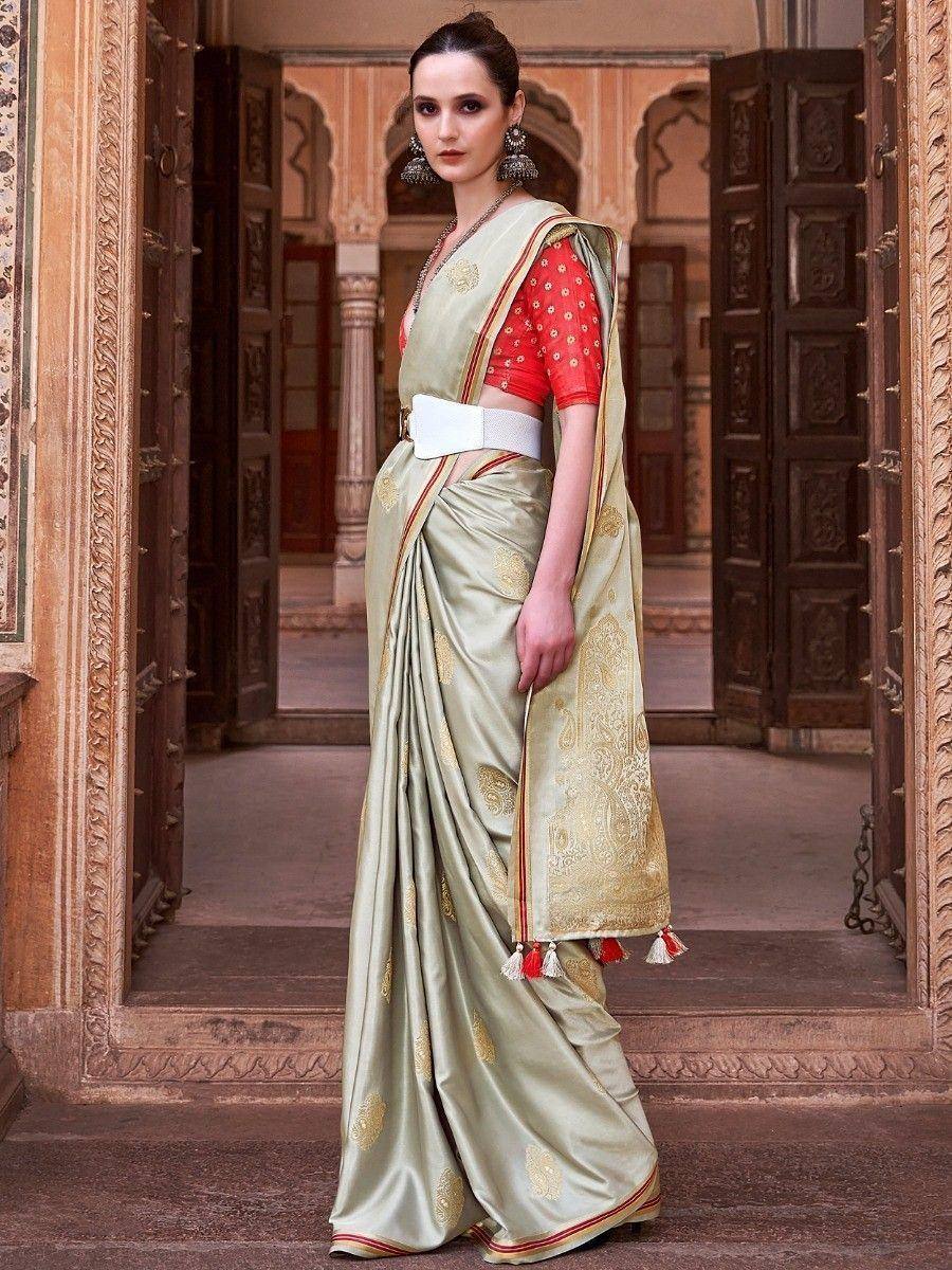 Elegant olive green saree with gold paisley print, red blouse, and white belt, styled for Indian ethnic wear