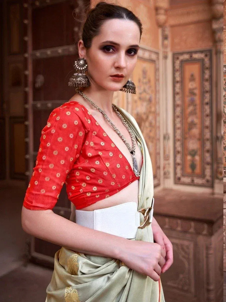 Woman in red floral blouse and olive saree with white belt, traditional Indian ethnic wear