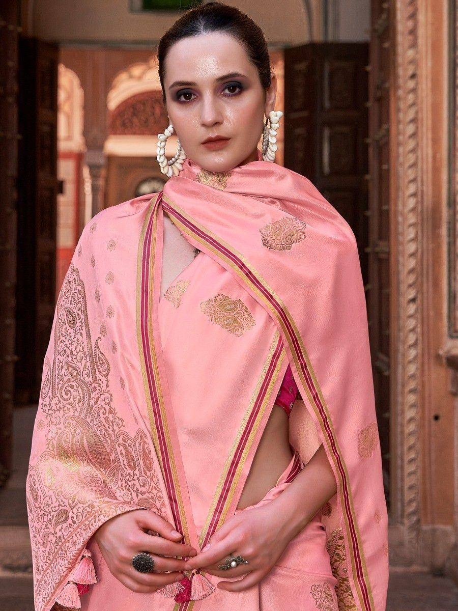 Pink designer saree with gold paisley embroidery and tassels, styled with statement earrings for ethnic wear