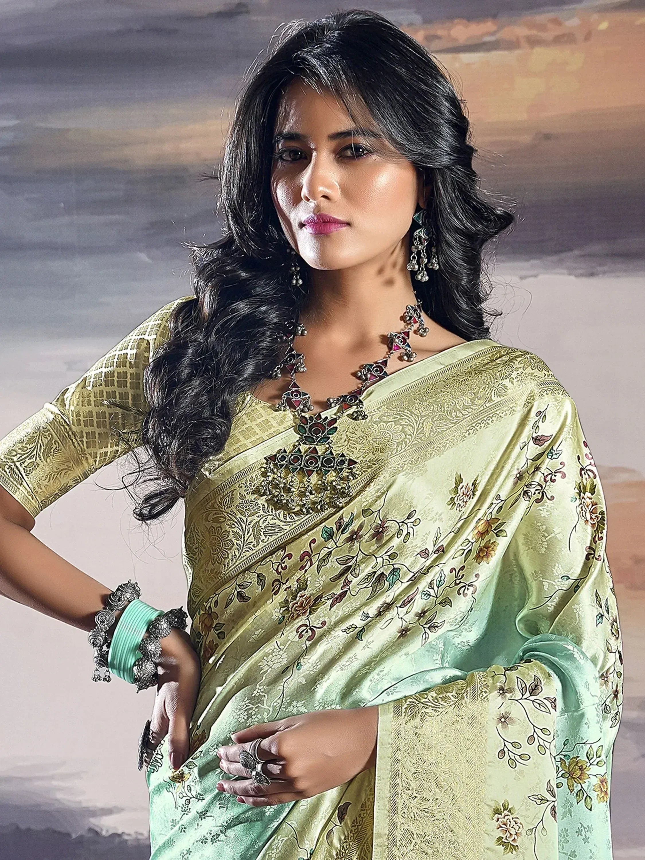 Woman in elegant light green floral saree with gold embroidery, traditional Indian ethnic wear