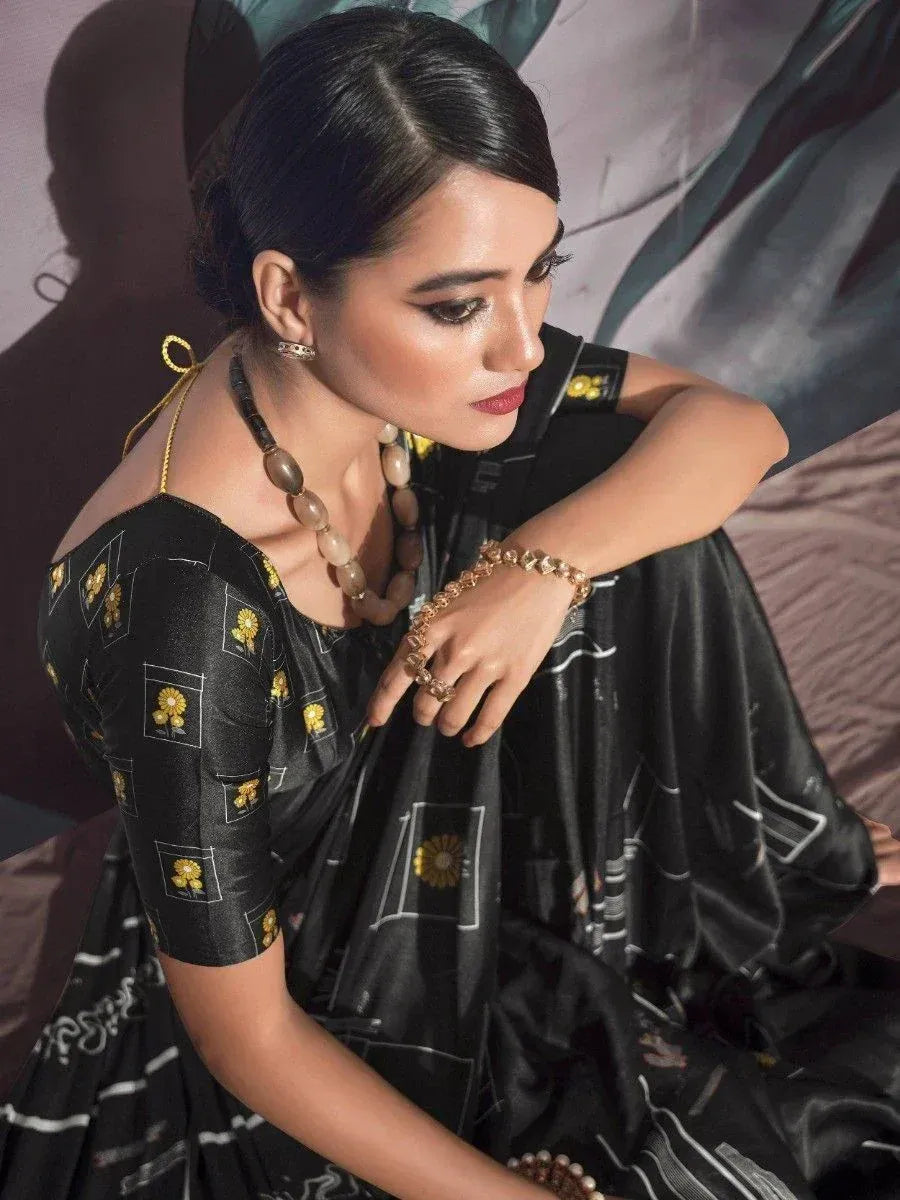 Black printed ethnic gown with gold floral motifs, styled with statement jewelry for festive occasions.