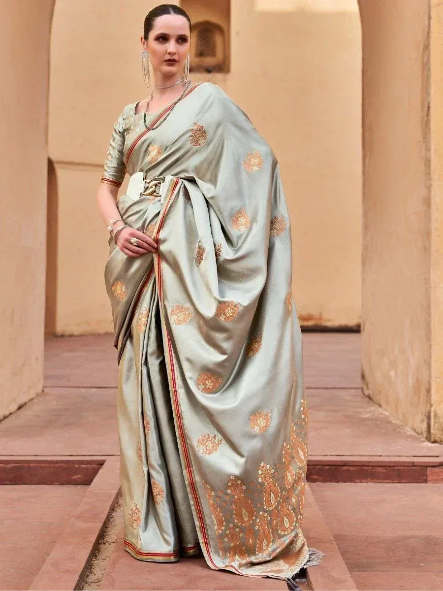 Elegant light green saree with gold floral embroidery and red border, styled with matching blouse for Indian ethnic wear