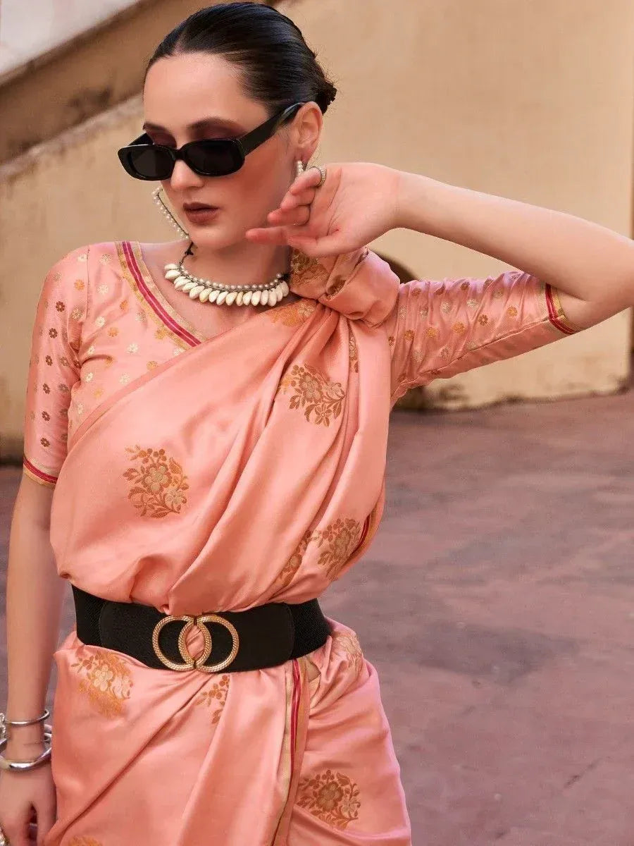 Pink floral ethnic saree with gold embroidery, black belt, and statement jewelry for modern Indian wear