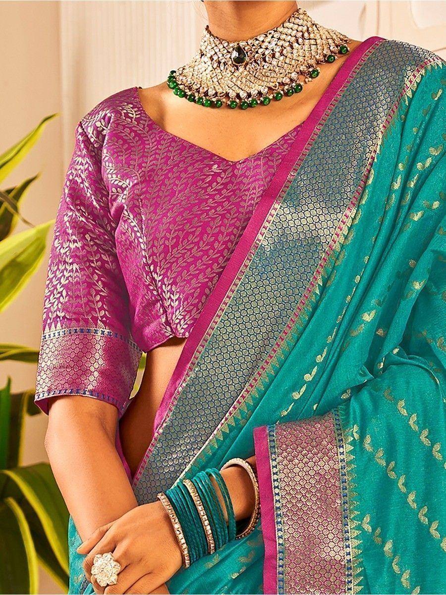 Teal saree with pink blouse, gold embroidery, and traditional Indian jewelry for ethnic wear