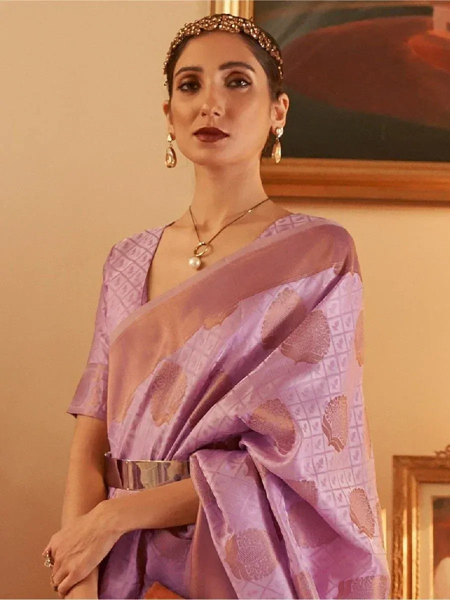Purple designer saree with gold motifs, styled with statement jewelry and a metallic belt for ethnic occasions.