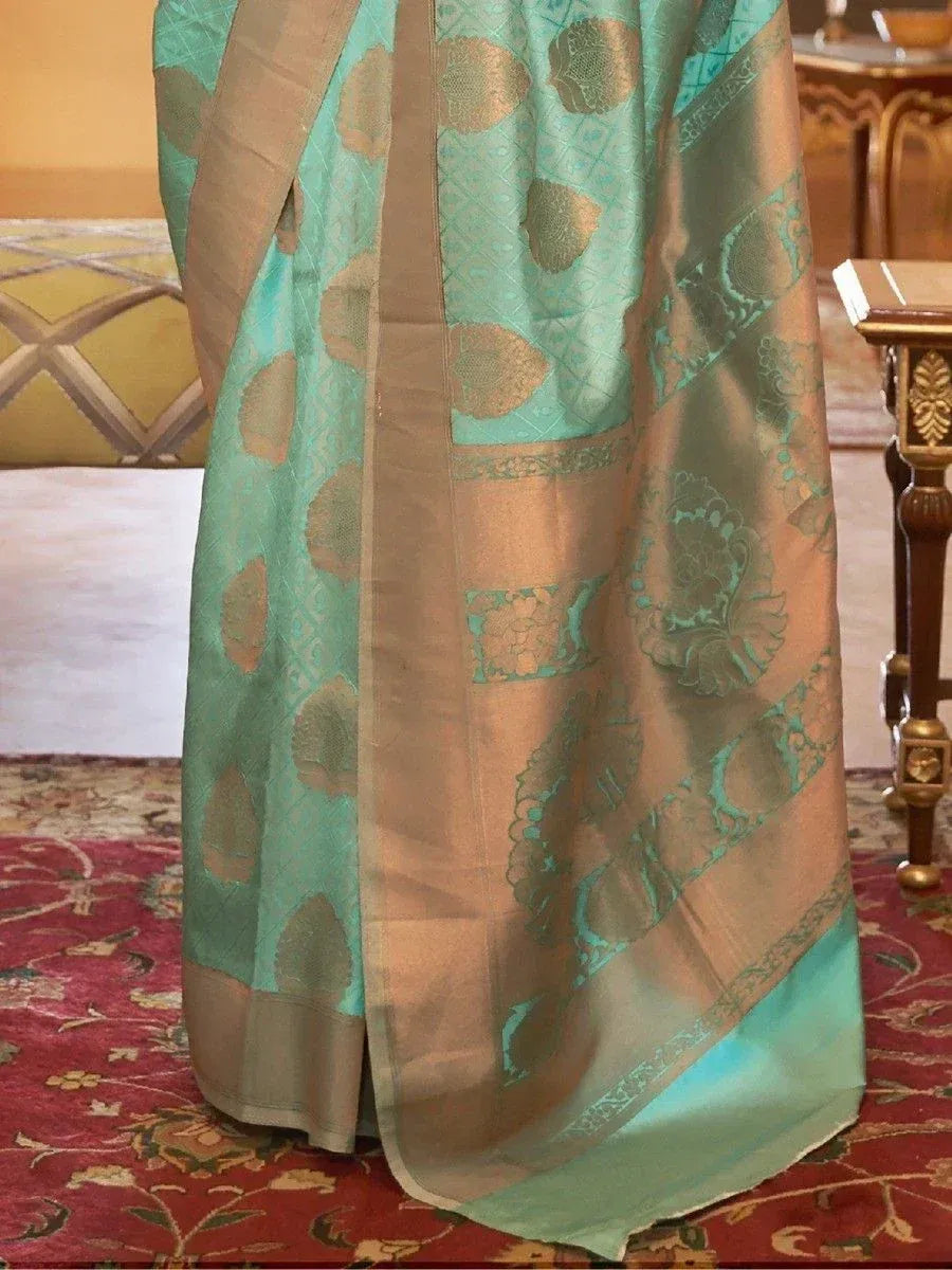Turquoise and gold designer saree with floral motifs, perfect for ethnic occasions