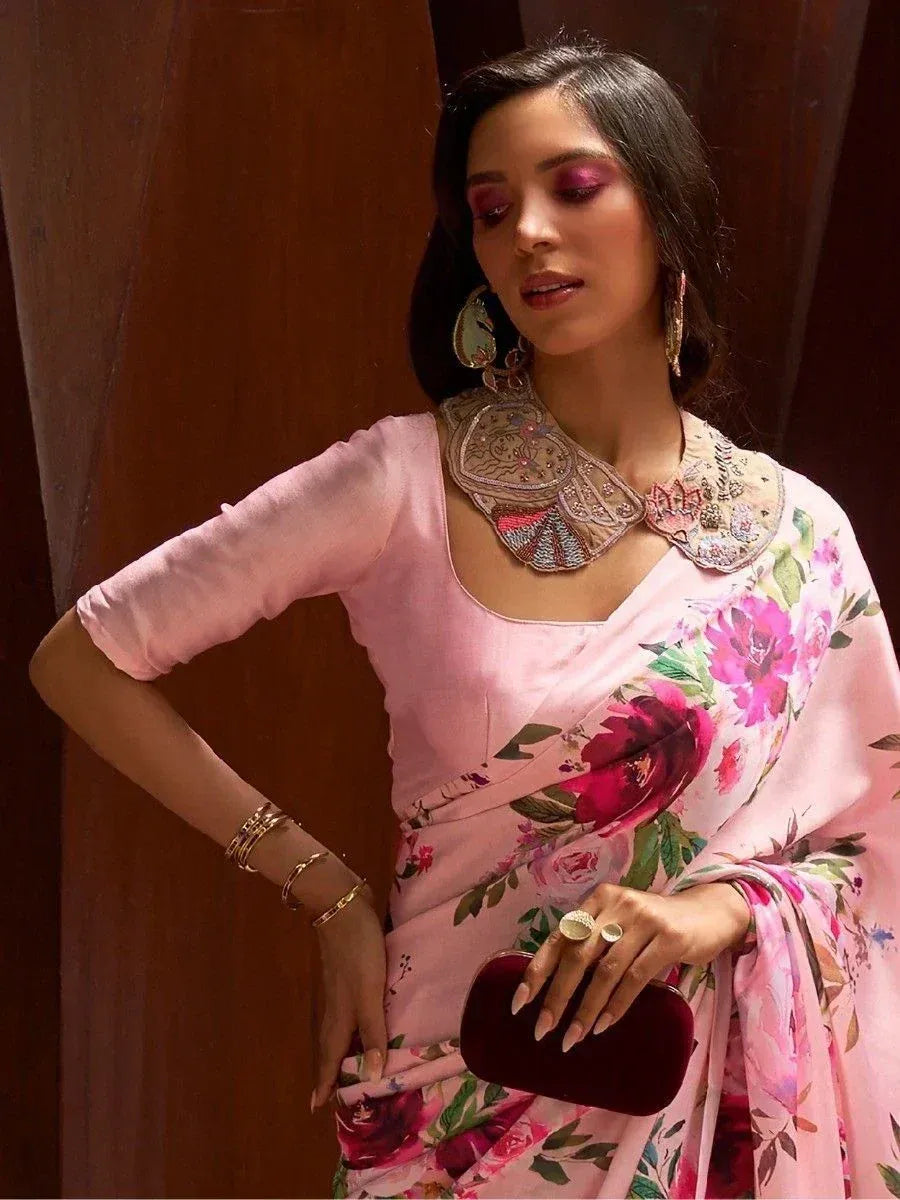 Pink floral saree with embroidered collar, styled with gold jewelry and clutch for ethnic occasions