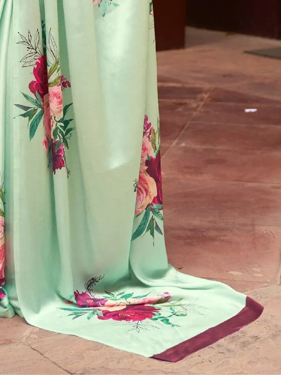 Mint green ethnic gown with vibrant floral print and maroon border, perfect for Indian occasions