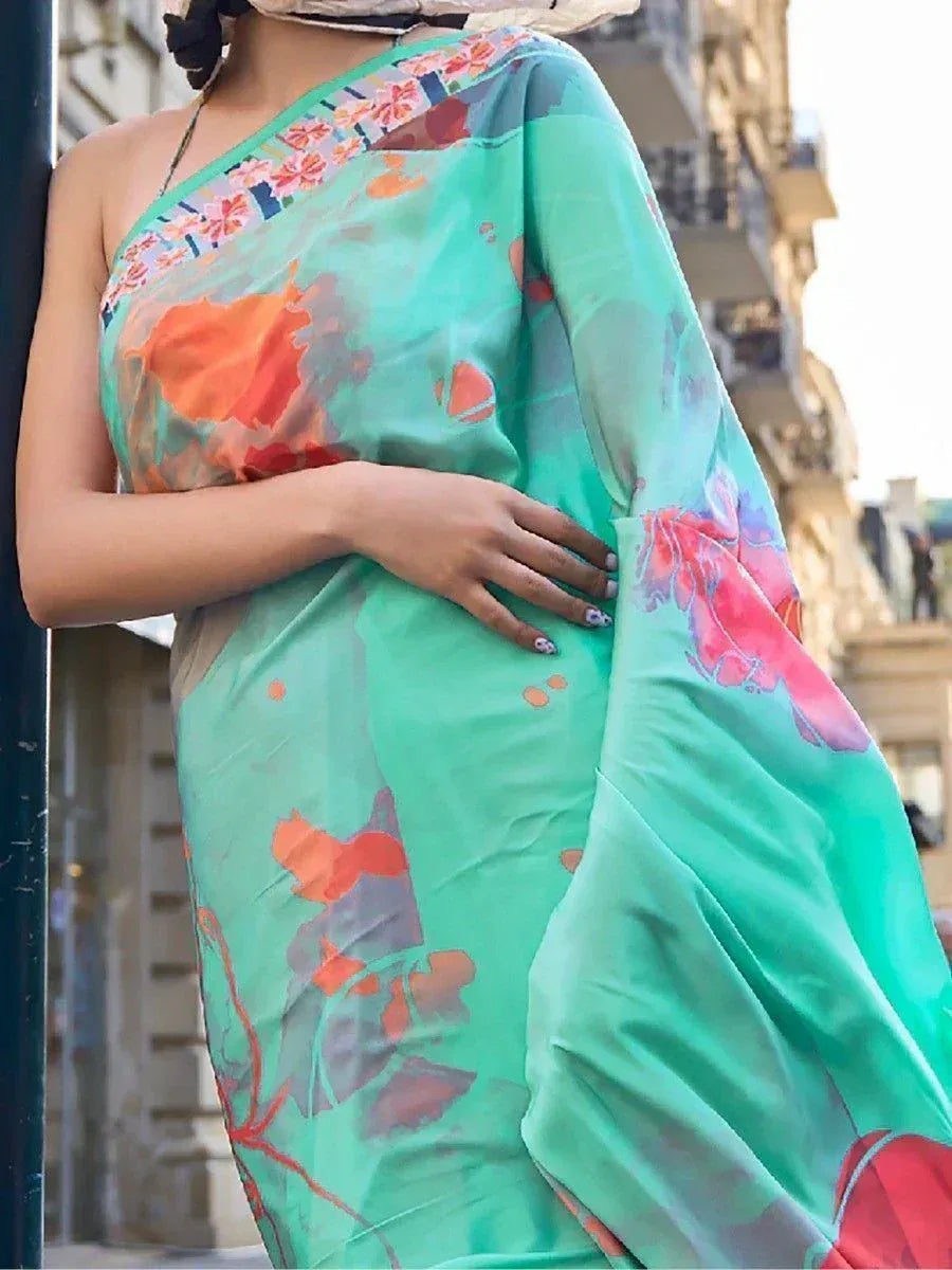 Mint green floral saree with vibrant print, styled for ethnic wear