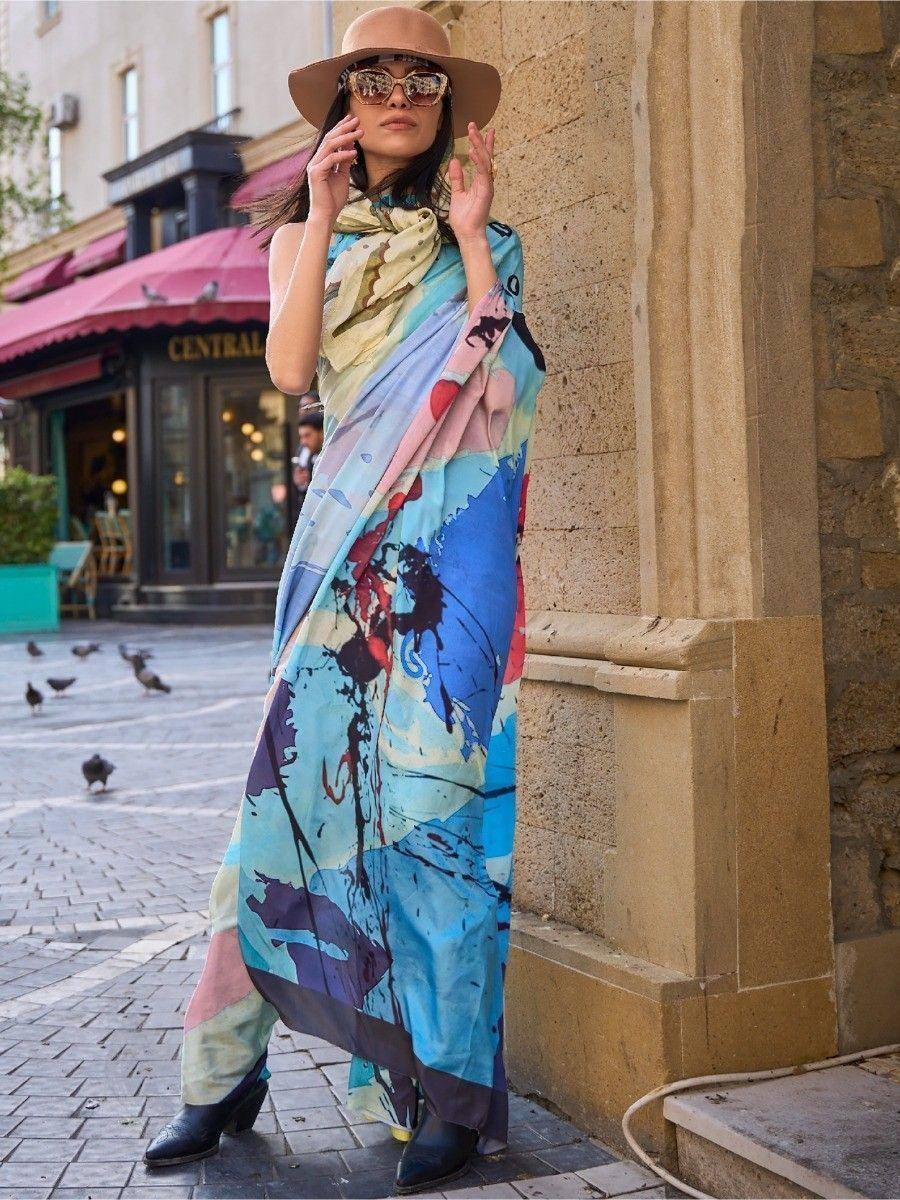 Woman wearing colorful abstract printed ethnic gown with wide-brim hat, stylish streetwear look