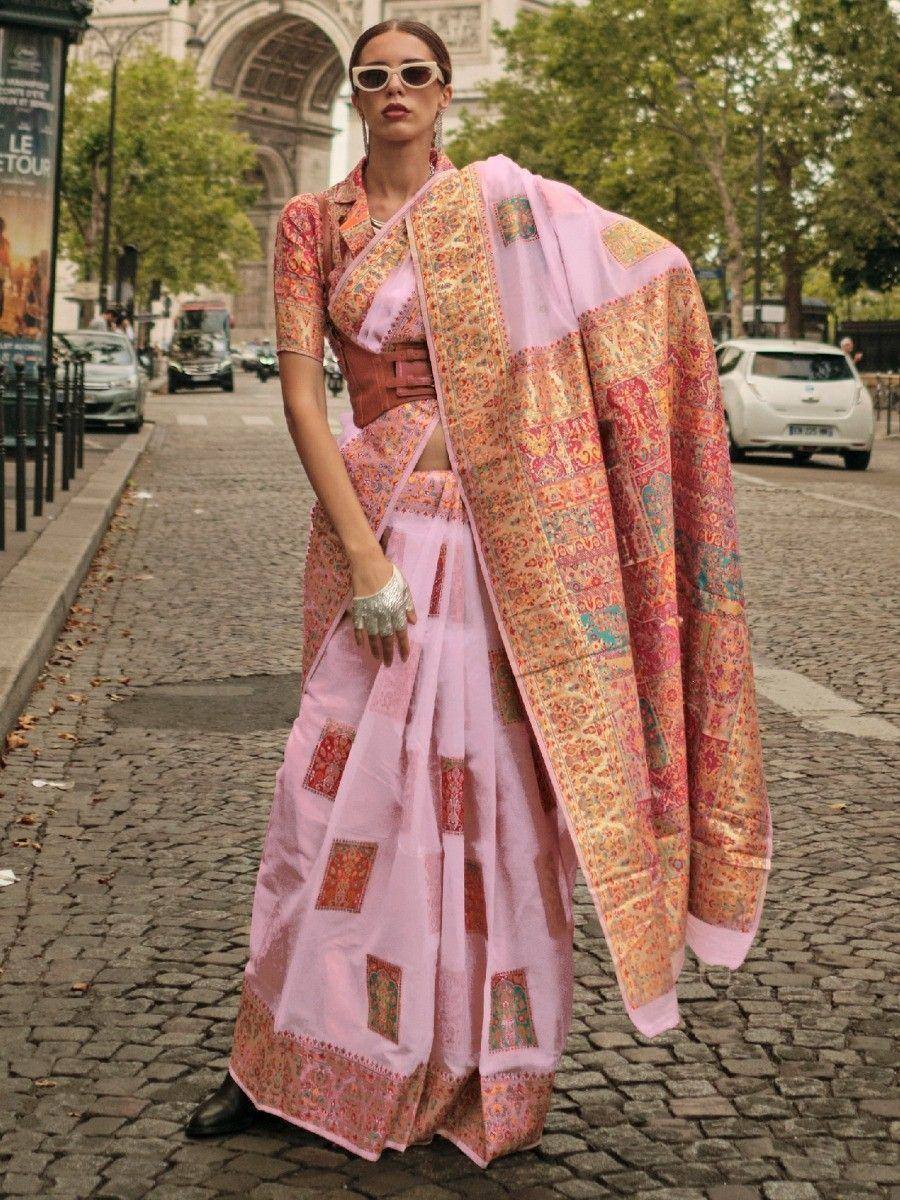 Pink printed saree with golden border, styled with crop top and belt, worn on Paris street