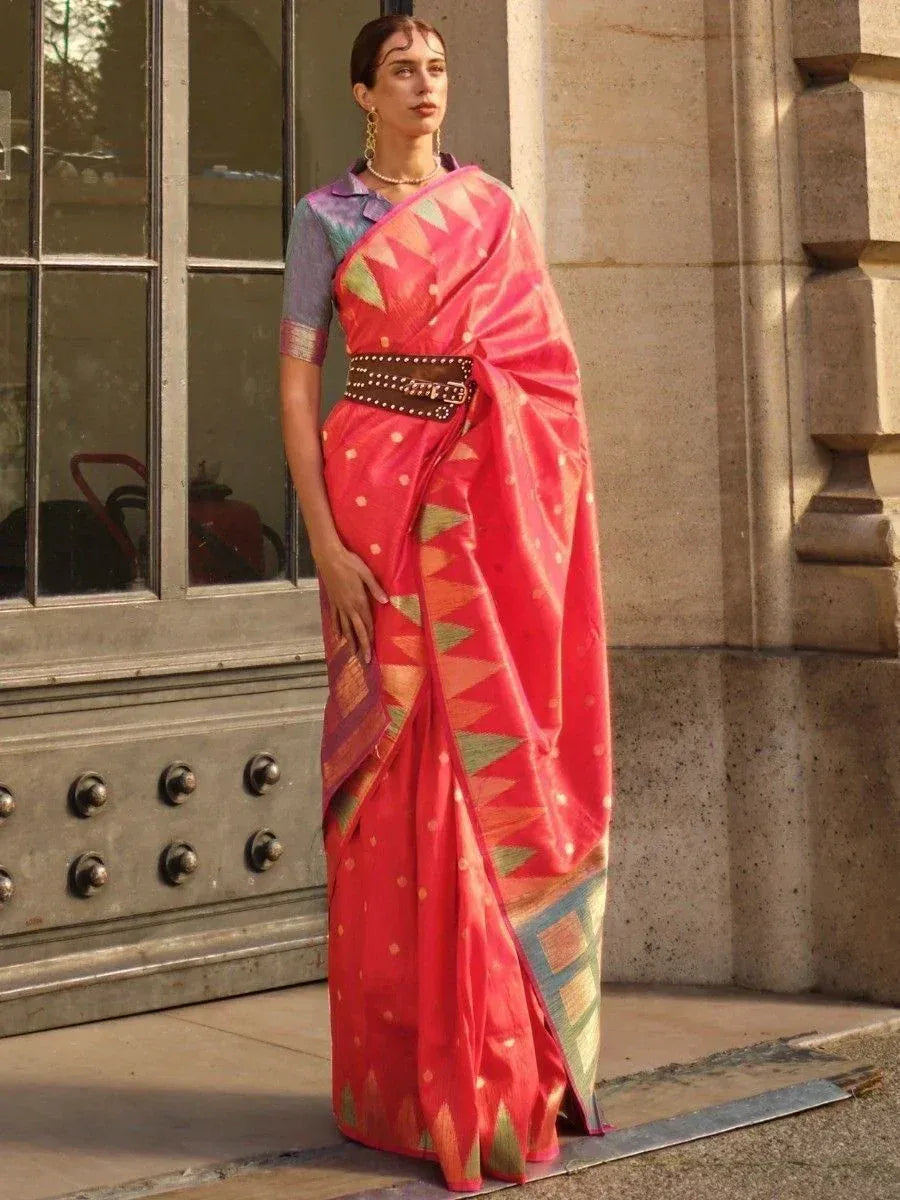 Woman in vibrant pink ethnic saree with geometric print, styled with belt and blouse, perfect for Indian occasions.