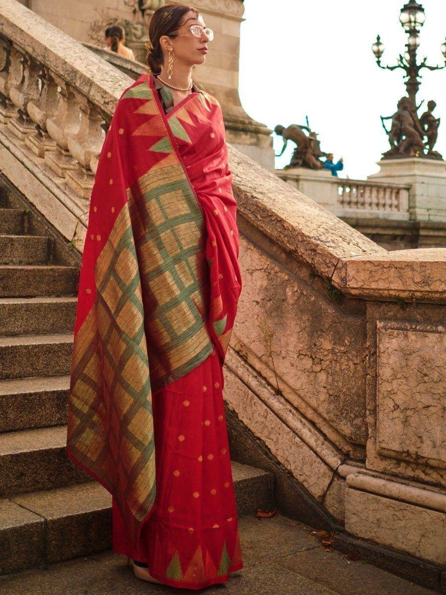 Woman in red ethnic saree with green gold geometric print, styled for Indian occasions