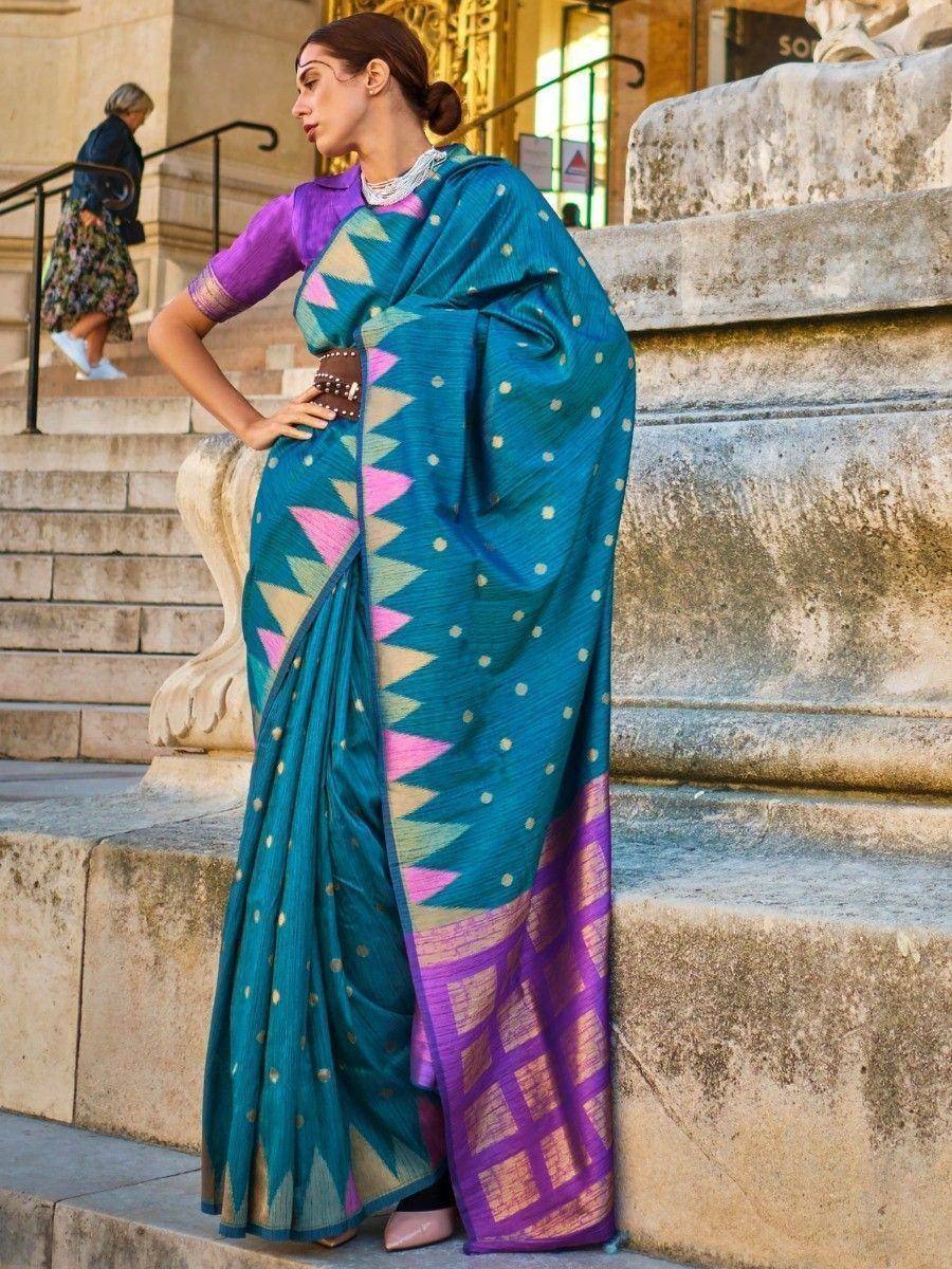 Teal saree with pink geometric border and purple blouse, styled for ethnic wear
