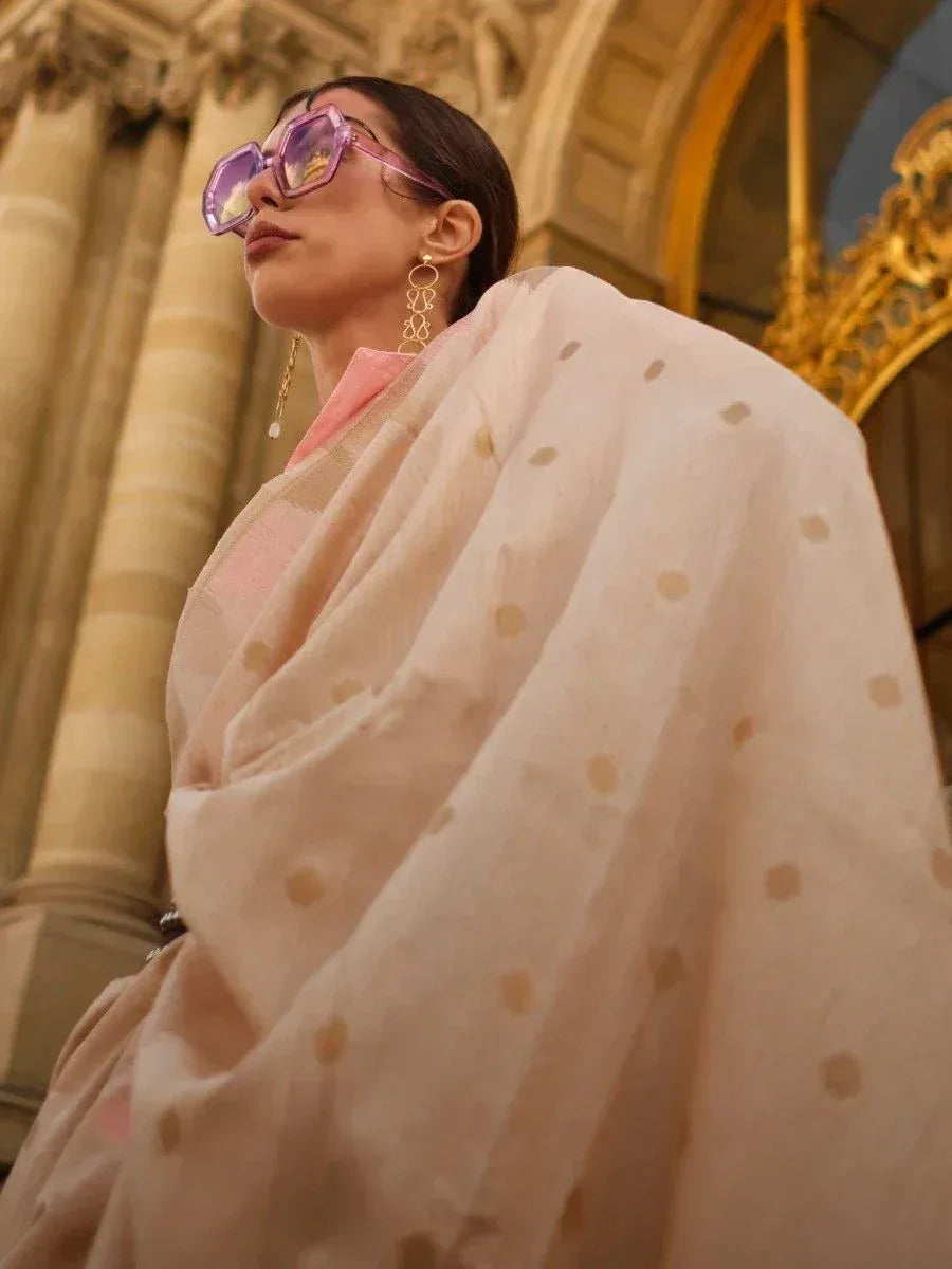 Woman in elegant ethnic saree with polka dots, pink blouse, and statement sunglasses, styled for modern Indian fashion.
