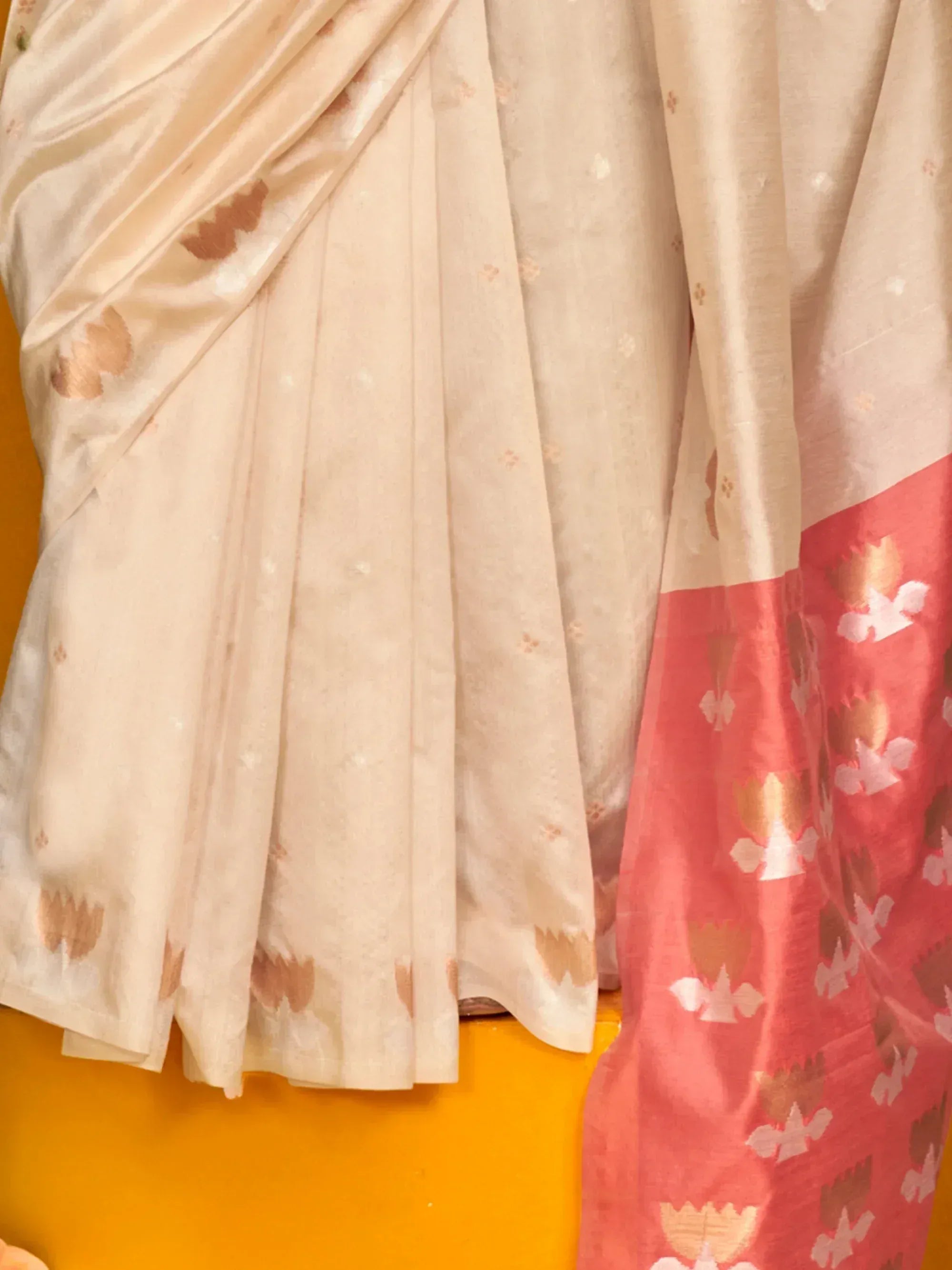 Cream and coral floral print saree with pleated drape, ideal for ethnic wear occasions.
