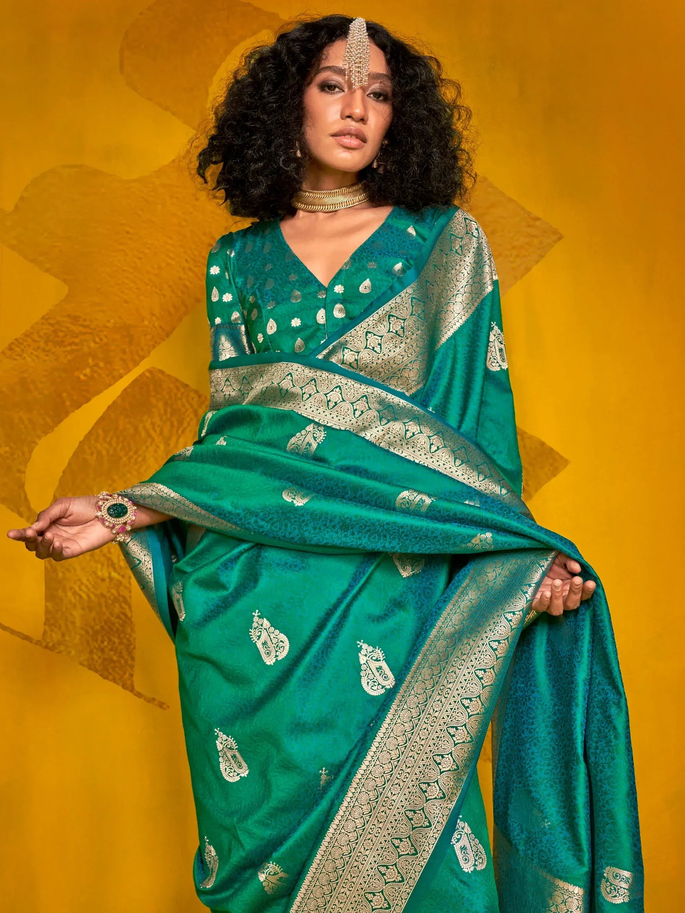 Emerald green designer saree with gold zari work, perfect for Indian ethnic wear occasions.