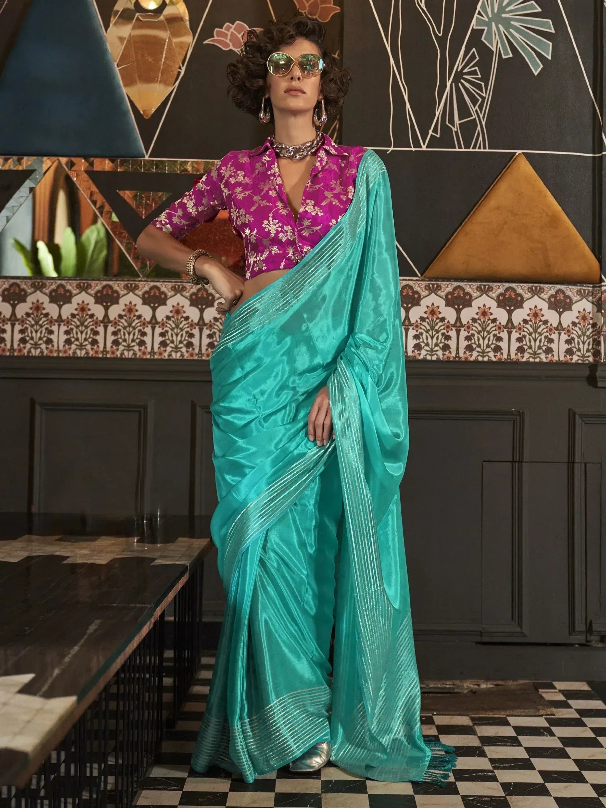 Stylish turquoise saree with pink floral blouse, perfect for ethnic fashion events