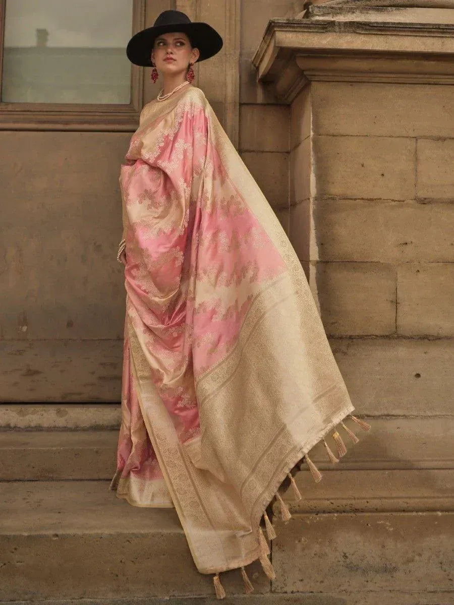 Pink and gold designer saree with floral print and tassels, styled with black hat for ethnic wear