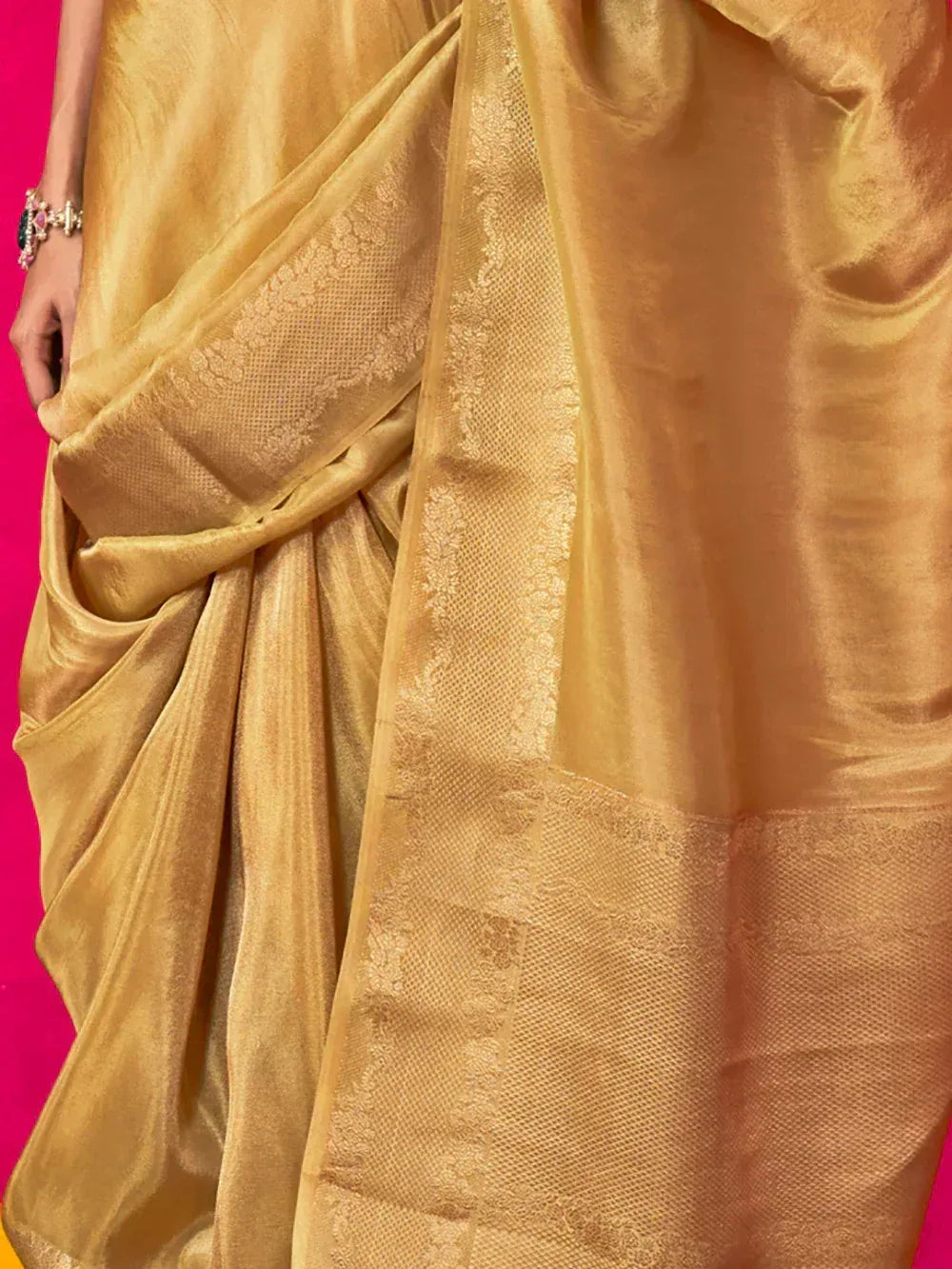 Golden designer saree with intricate woven border, perfect for ethnic occasions