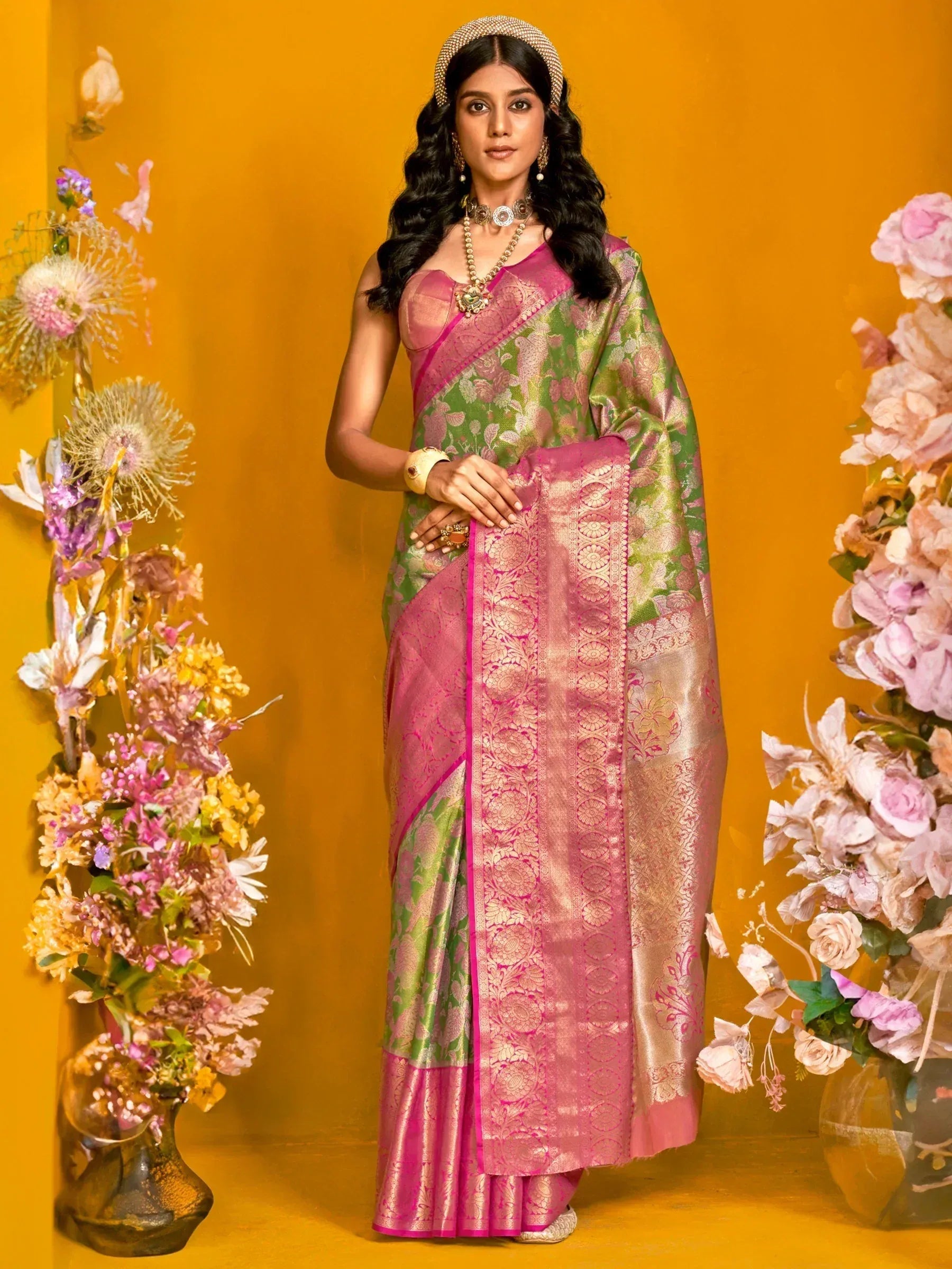 Elegant green and pink designer saree with intricate gold embroidery, perfect for ethnic occasions.