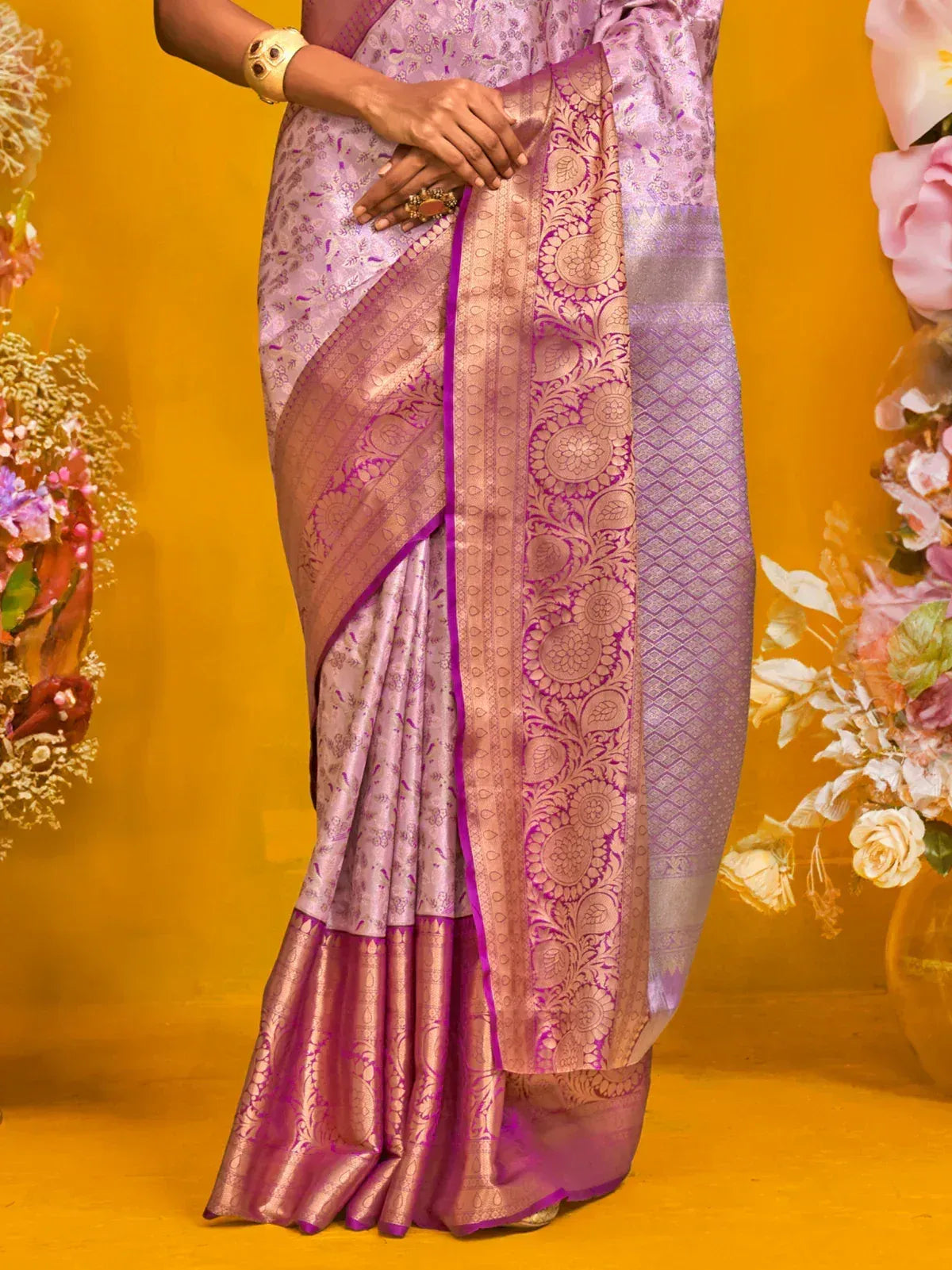 Elegant purple and gold designer saree with intricate floral patterns and rich border detailing