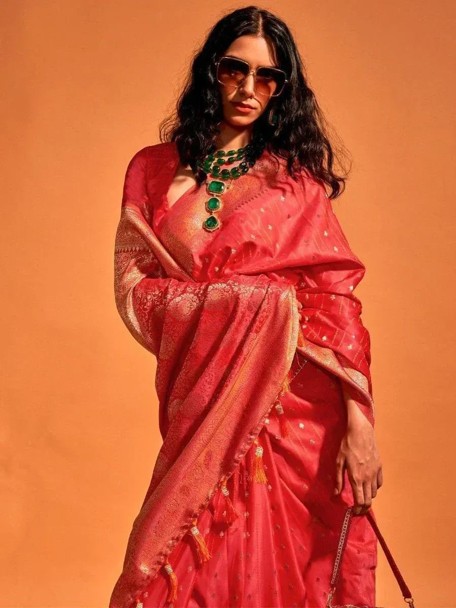 Stylish red ethnic saree with gold embroidery, green necklace, and sunglasses for modern Indian wear