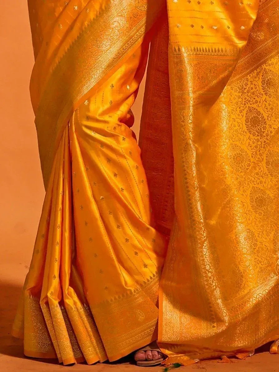 Golden silk saree with intricate zari work and traditional Indian ethnic design