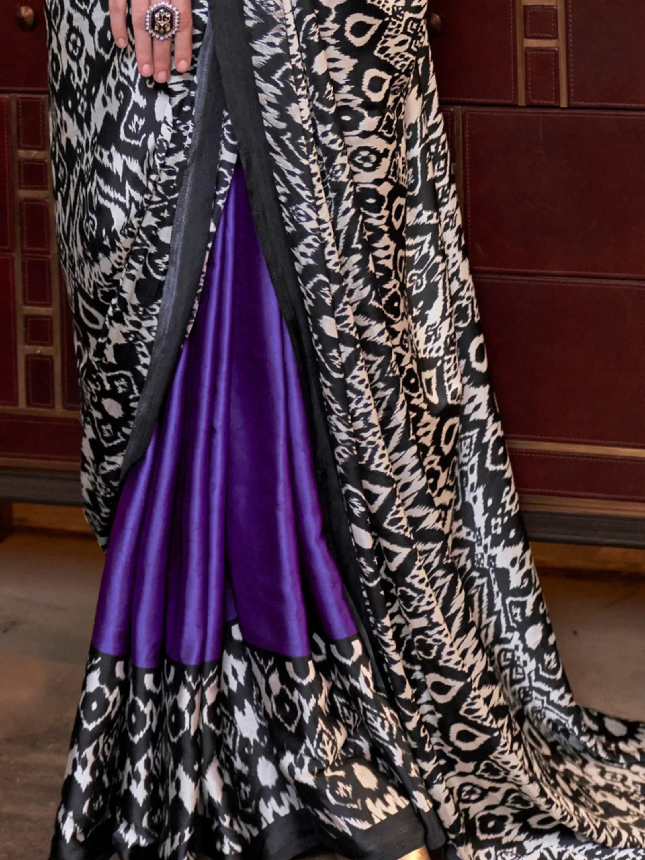 Black and white ikat print ethnic gown with purple satin lining, styled with statement ring