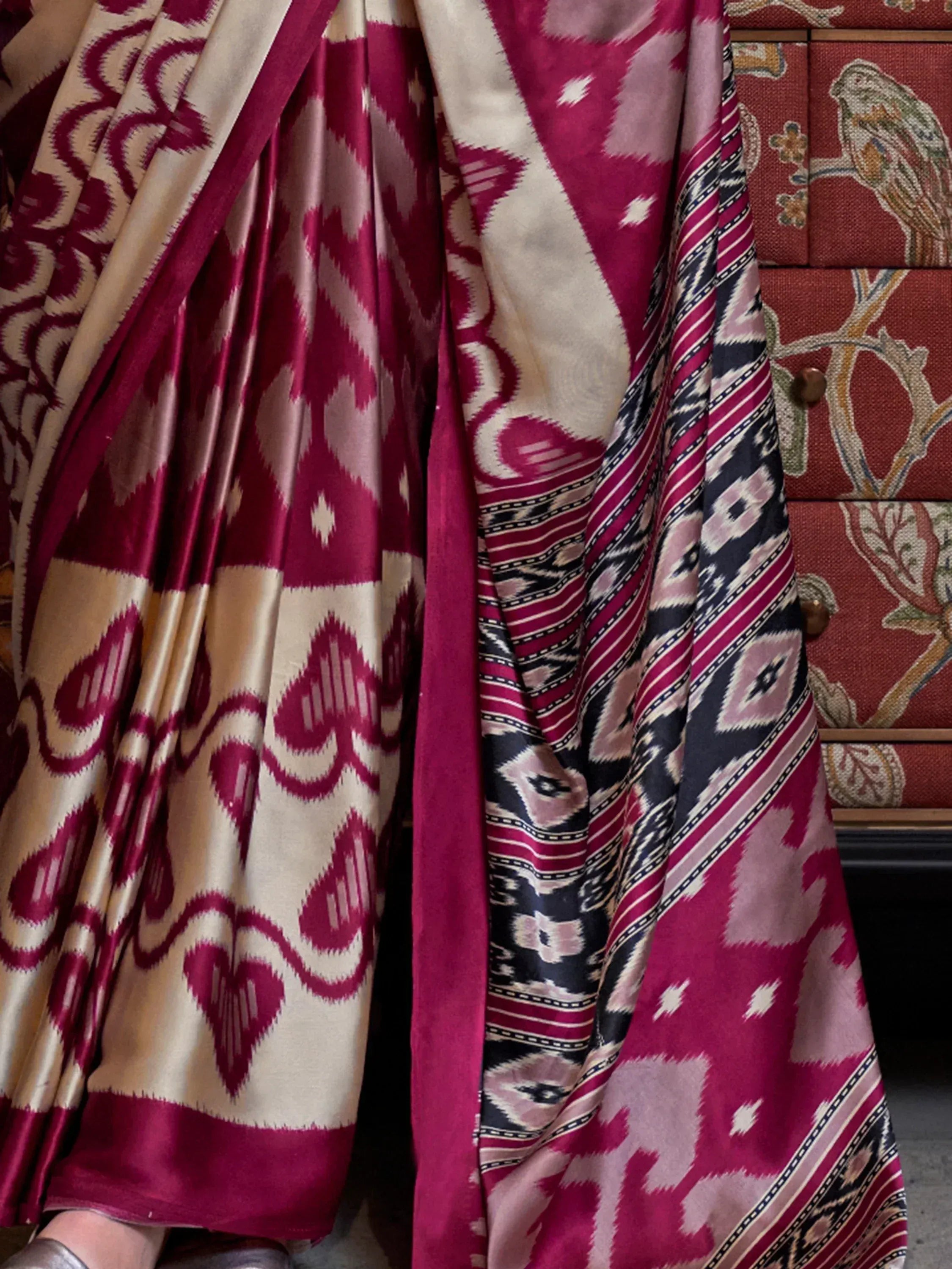 Elegant maroon and cream ikat saree with geometric patterns, perfect for ethnic wear occasions.