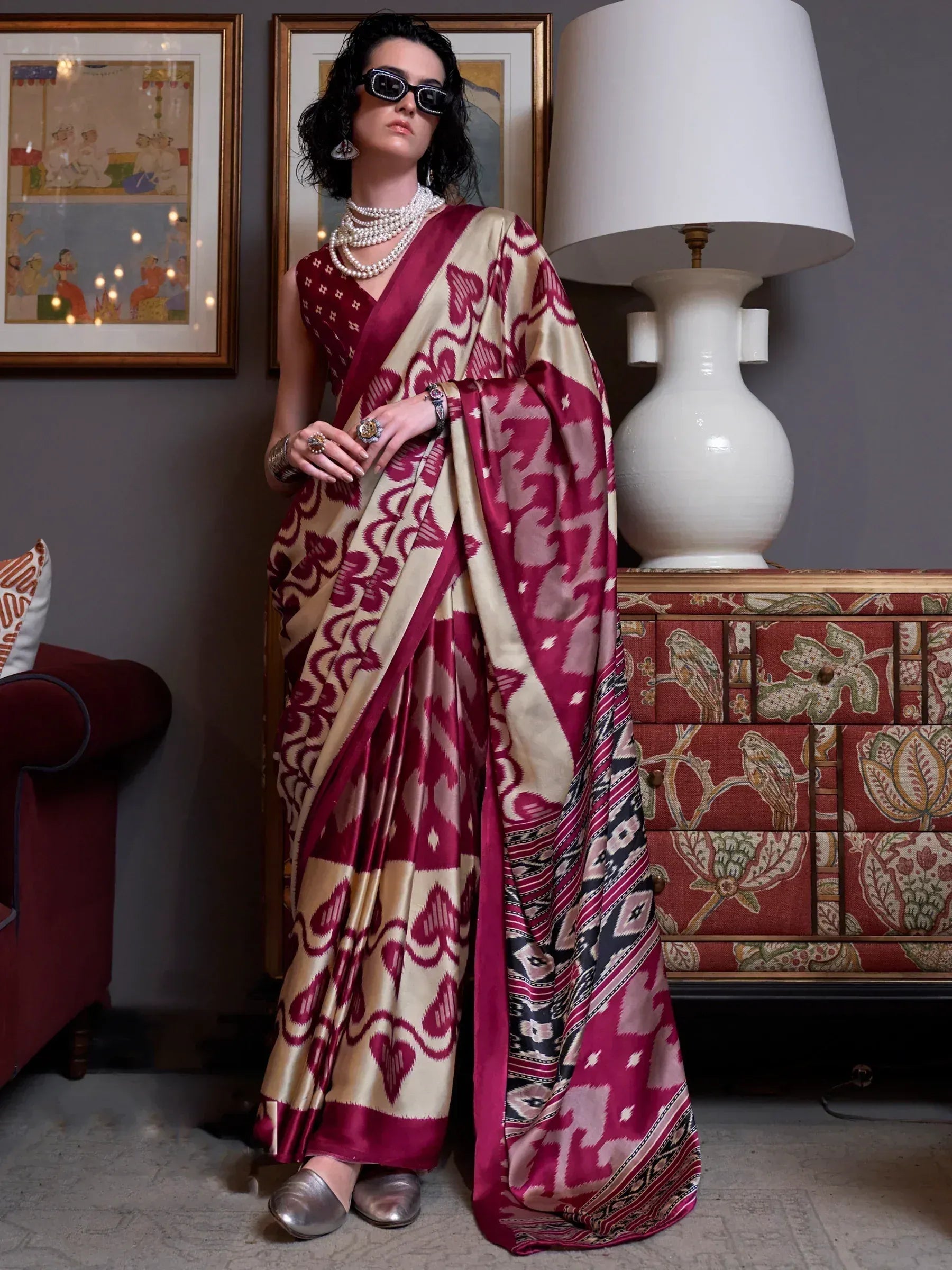 Woman in maroon and beige ikat print saree with pearl jewelry, stylish ethnic wear for occasions