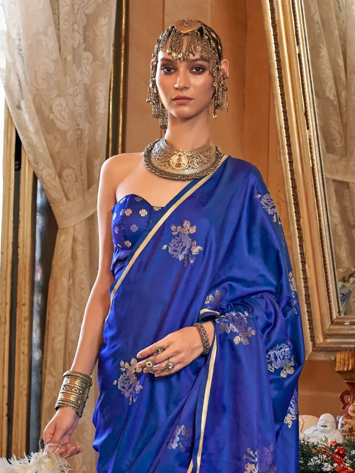 Royal blue embroidered saree with gold floral motifs, paired with traditional Indian jewelry for ethnic wear.