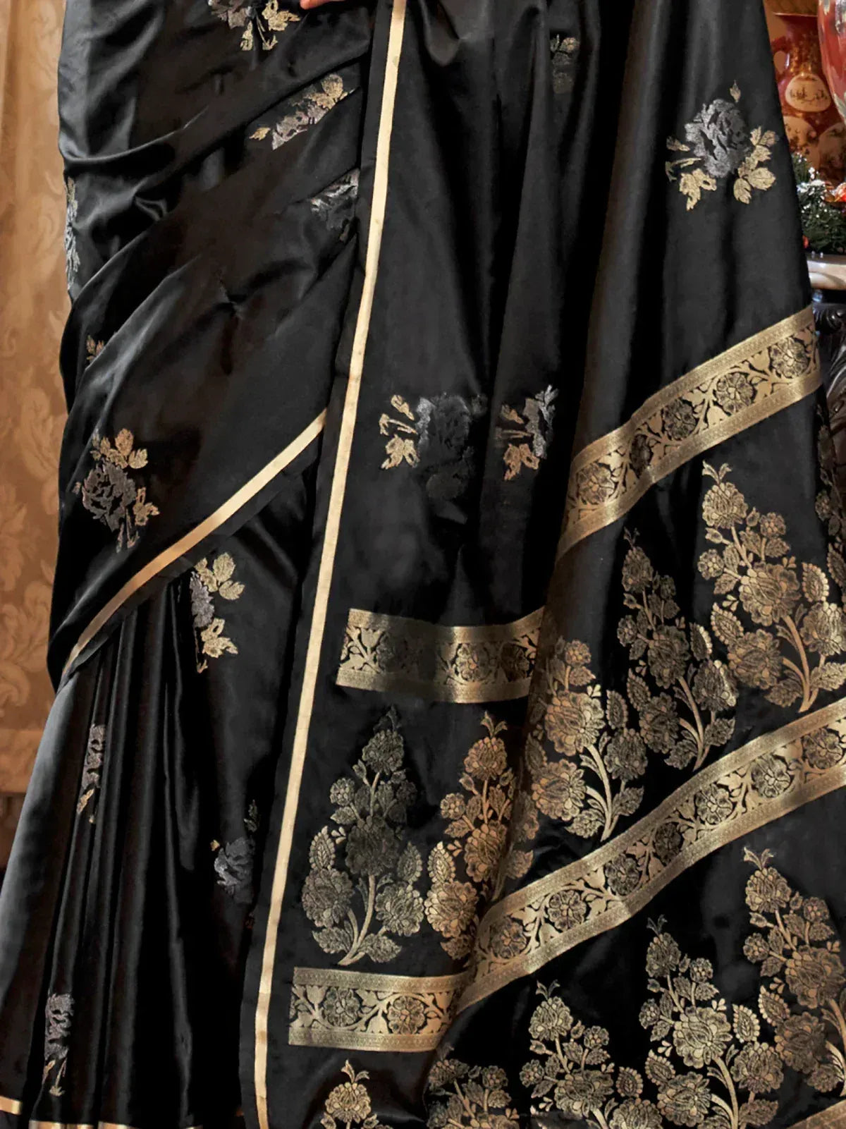 Black silk saree with gold floral embroidery and border, elegant Indian ethnic wear